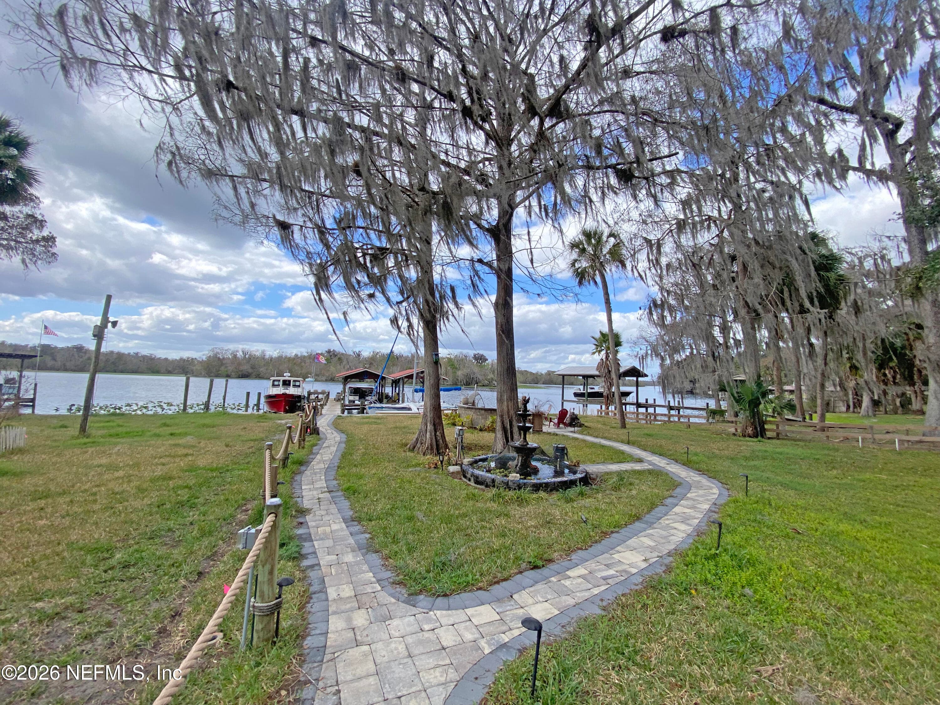 Pavers to dock and firepit with wifi connected lighting and koi pond/fountain — 101 ORANGE Street, Satsuma, FL 32189