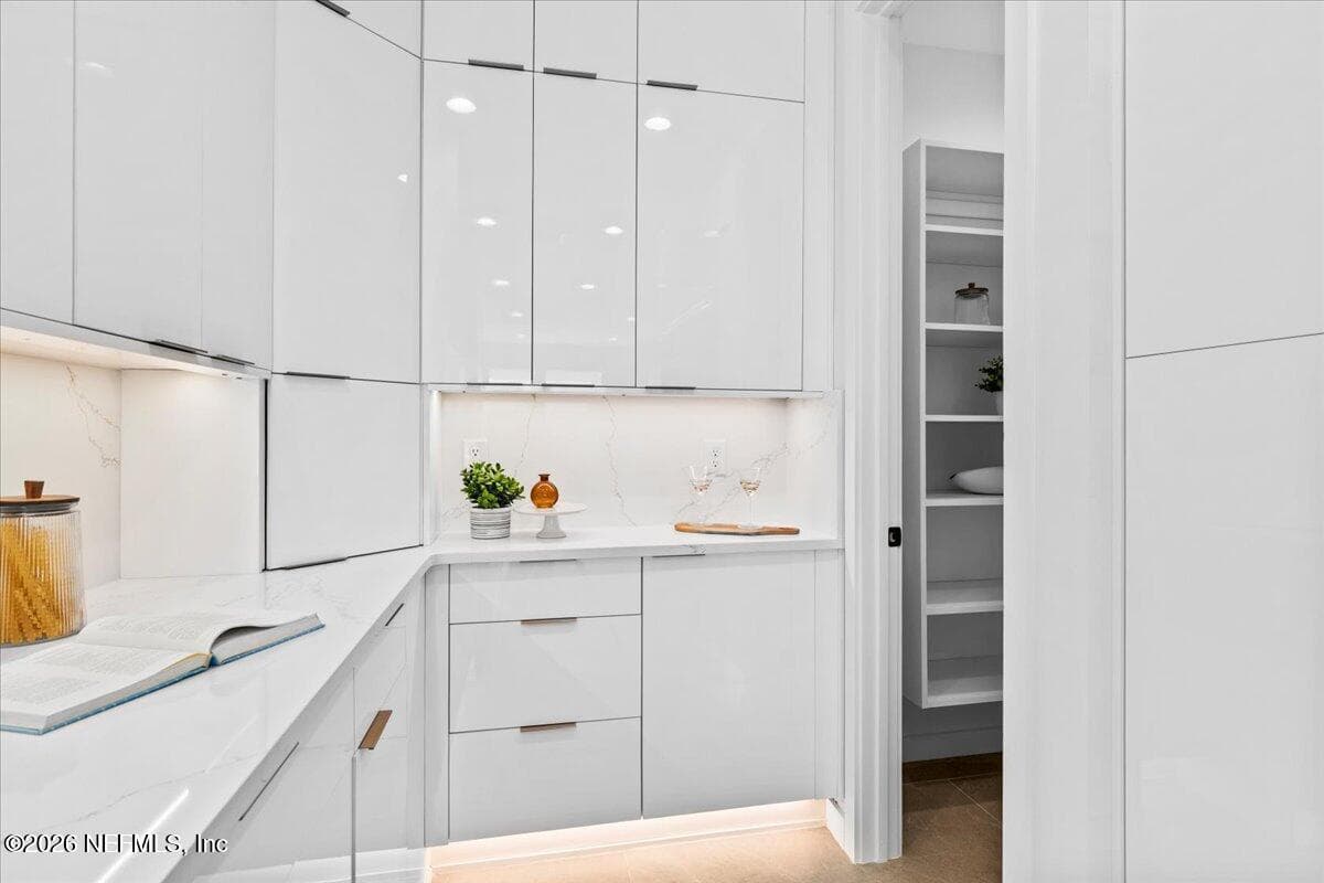 Modern Kitchen Cabinets to the ceiling with a glimpse of the walk-in pantry — 118 13TH Avenue S 103 C, Jacksonville Beach, FL 32250