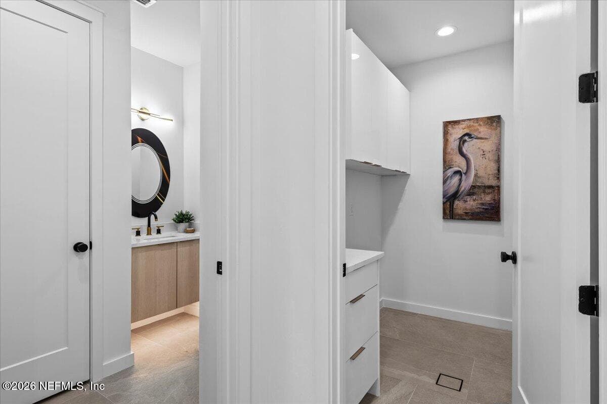 Standing in the Vestibule viewing the Laundry Room and Guest Powder Room — 118 13TH Avenue S 103 C, Jacksonville Beach, FL 32250