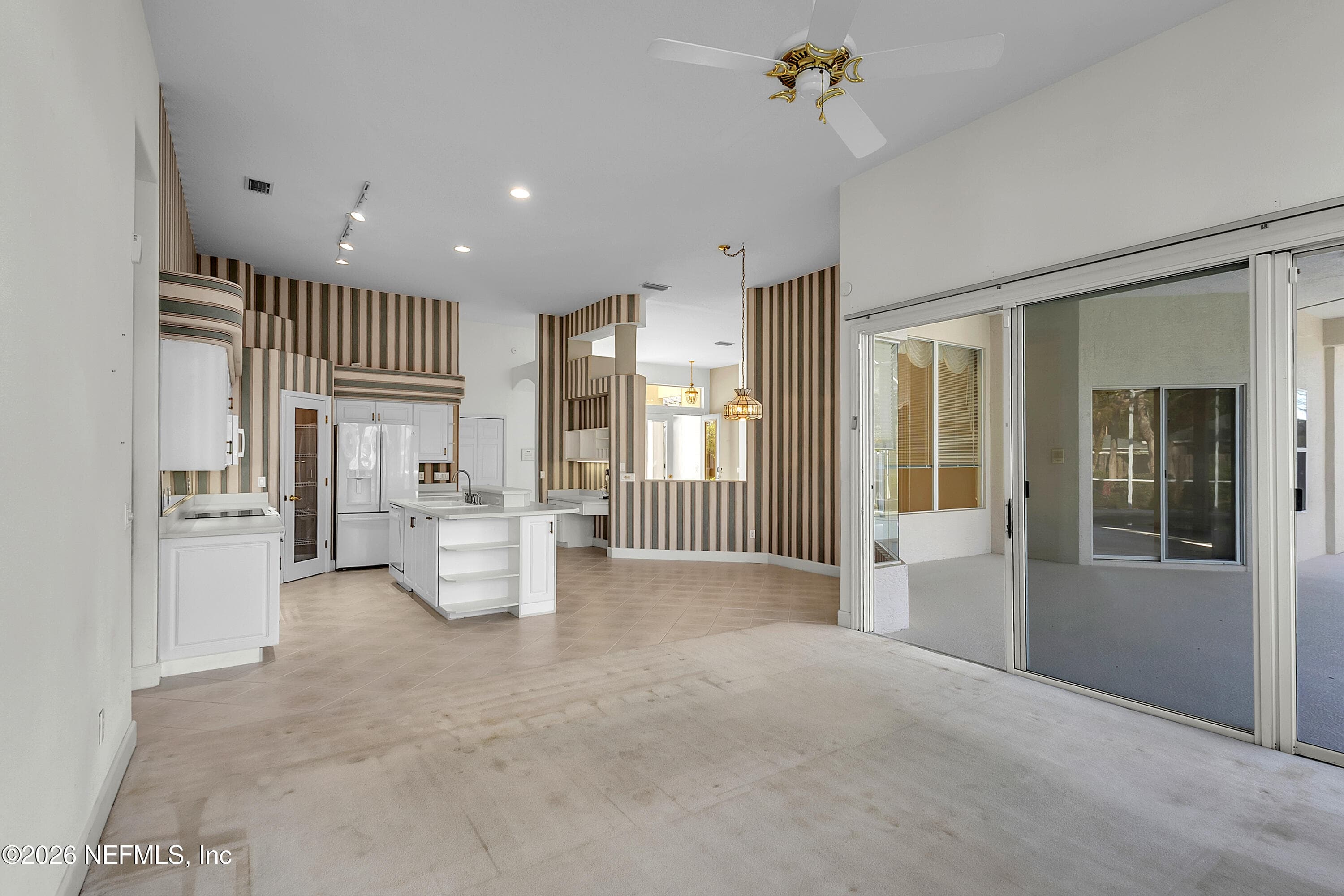 Great room open to the kitchen looking to the kitchen — 6030 SANCTUARY GARDEN Boulevard, Port Orange, FL 32128