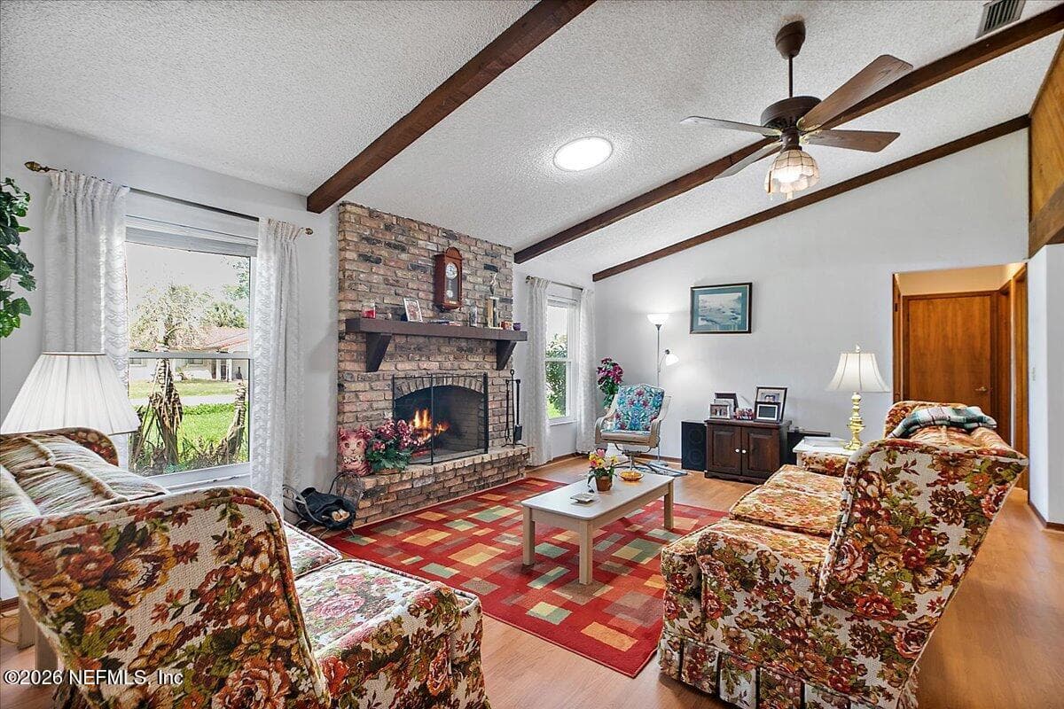 Cozy Living Room With Wood Bkuirning Fireplace for cool evenings. — 21 WESTFORD Lane, Palm Coast, FL 32164