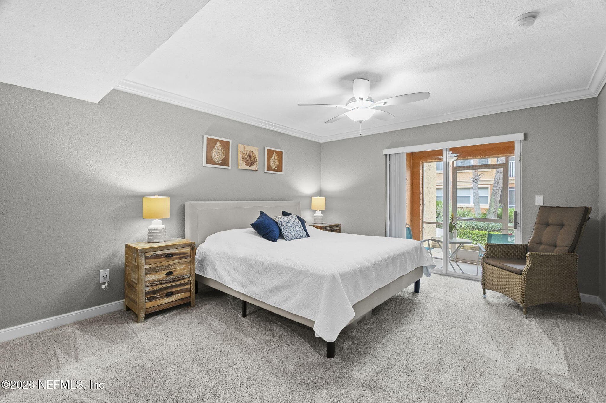 Large primary suite with room for seating and doorway to covered patio — 105 25TH Avenue S L11, Jacksonville Beach, FL 32250