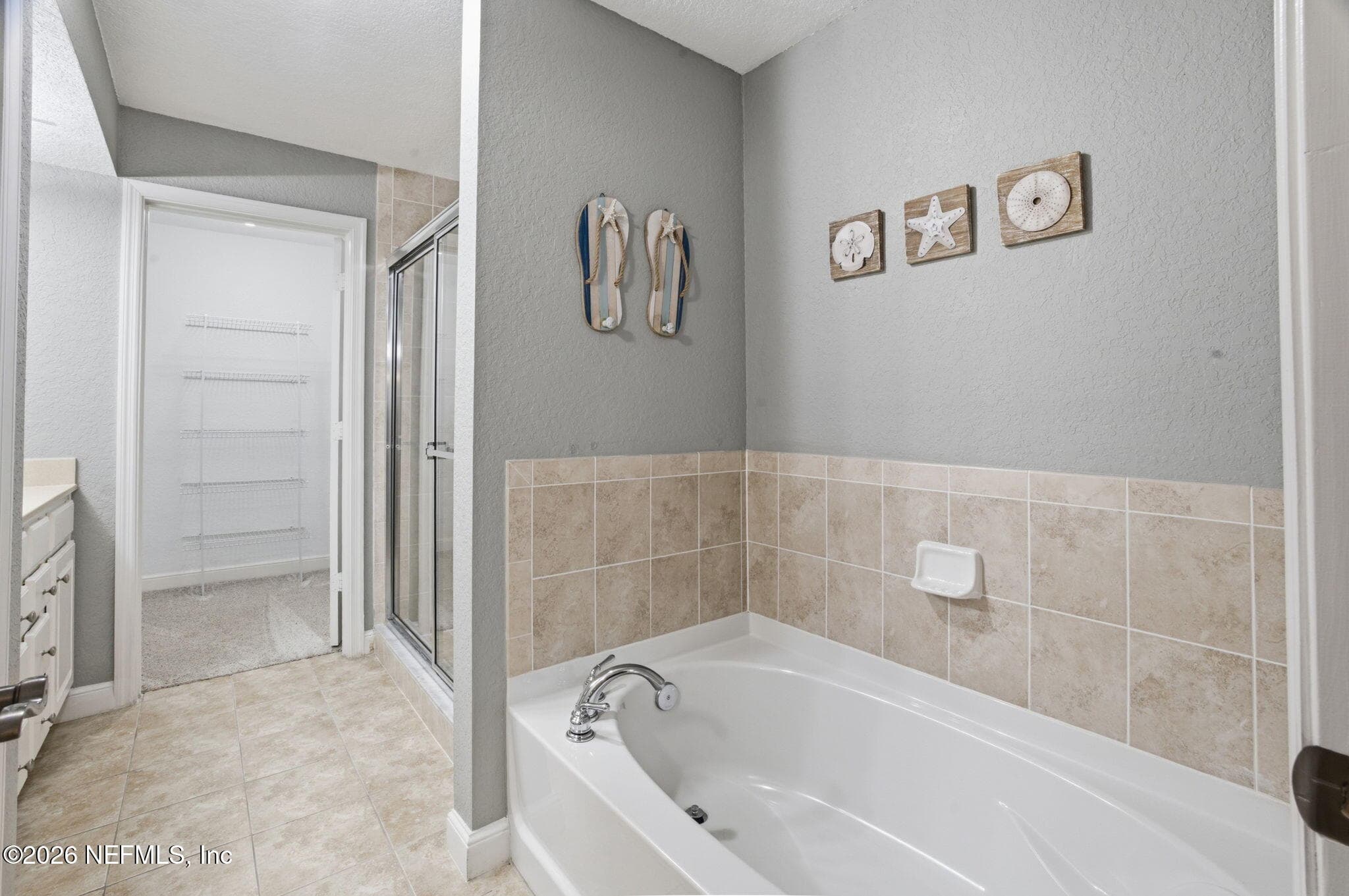 Primary with tub, glass shower double vanity and large closet — 105 25TH Avenue S L11, Jacksonville Beach, FL 32250