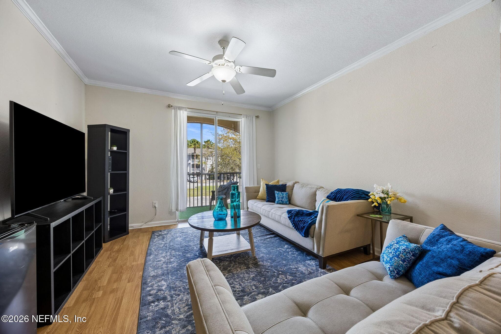 Large main living area with an open concept, LVT flooring, and sliding glass doors — 440 S VILLA SAN MARCO Drive 201, St. Augustine, FL 32086