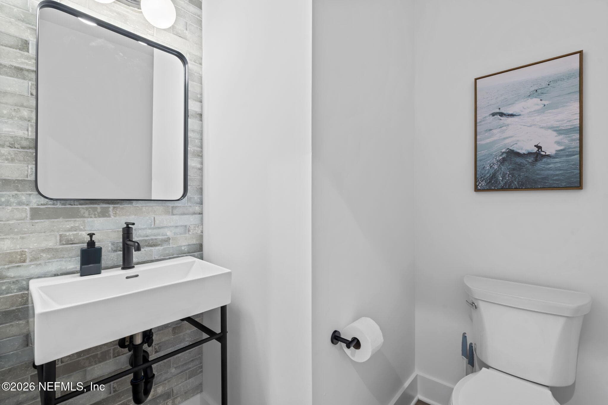 Downstairs half bath with tile feature — 921 2ND Avenue S, Jacksonville Beach, FL 32250