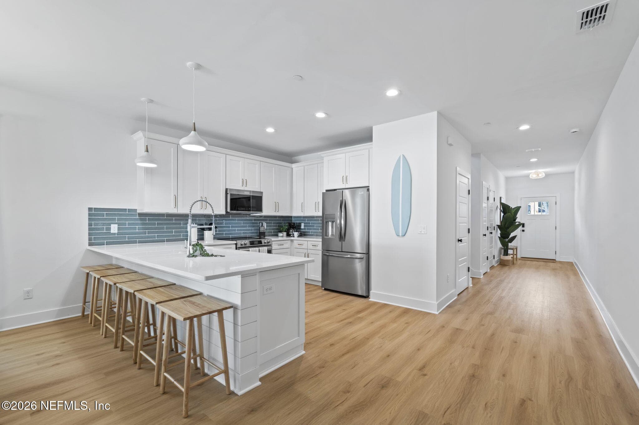 Tiled backsplash, expansive counter depth bar seating, shiplap feature wall under bar top — 921 2ND Avenue S, Jacksonville Beach, FL 32250