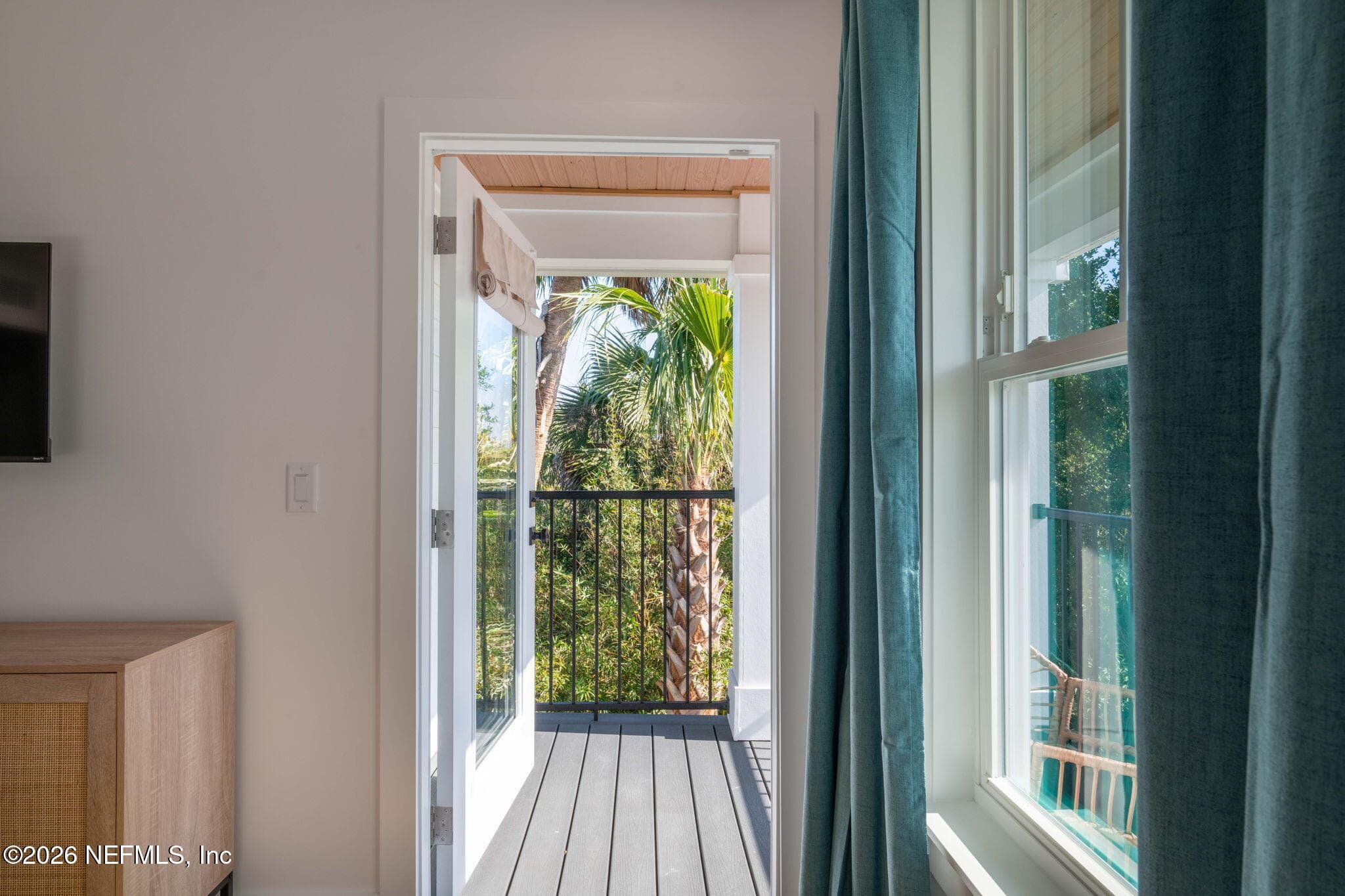2nd floor covered balcony off of primary bedroom with low maintenance composite decking and stained tongue and groove ceilings — 921 2ND Avenue S, Jacksonville Beach, FL 32250