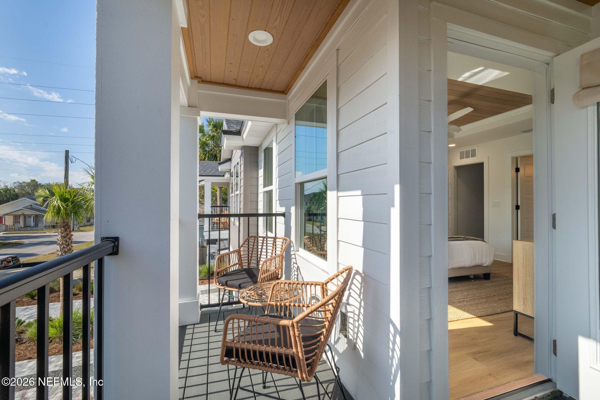 2nd floor covered balcony off of primary bedroom with low maintenance composite decking and stained tongue and groove ceilings — 921 2ND Avenue S, Jacksonville Beach, FL 32250