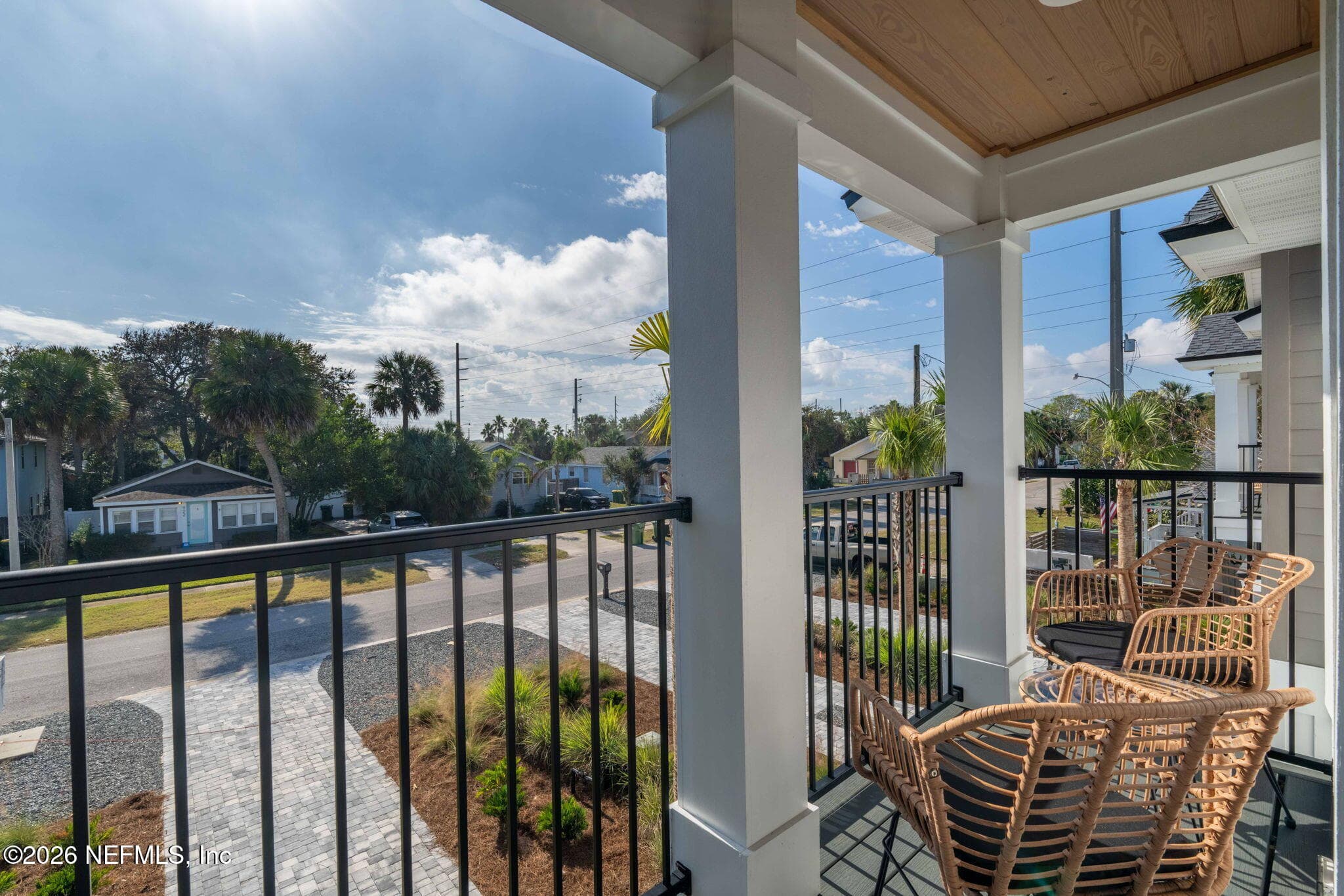 2nd floor covered balcony off of primary bedroom with low maintenance composite decking and stained tongue and groove ceilings — 921 2ND Avenue S, Jacksonville Beach, FL 32250