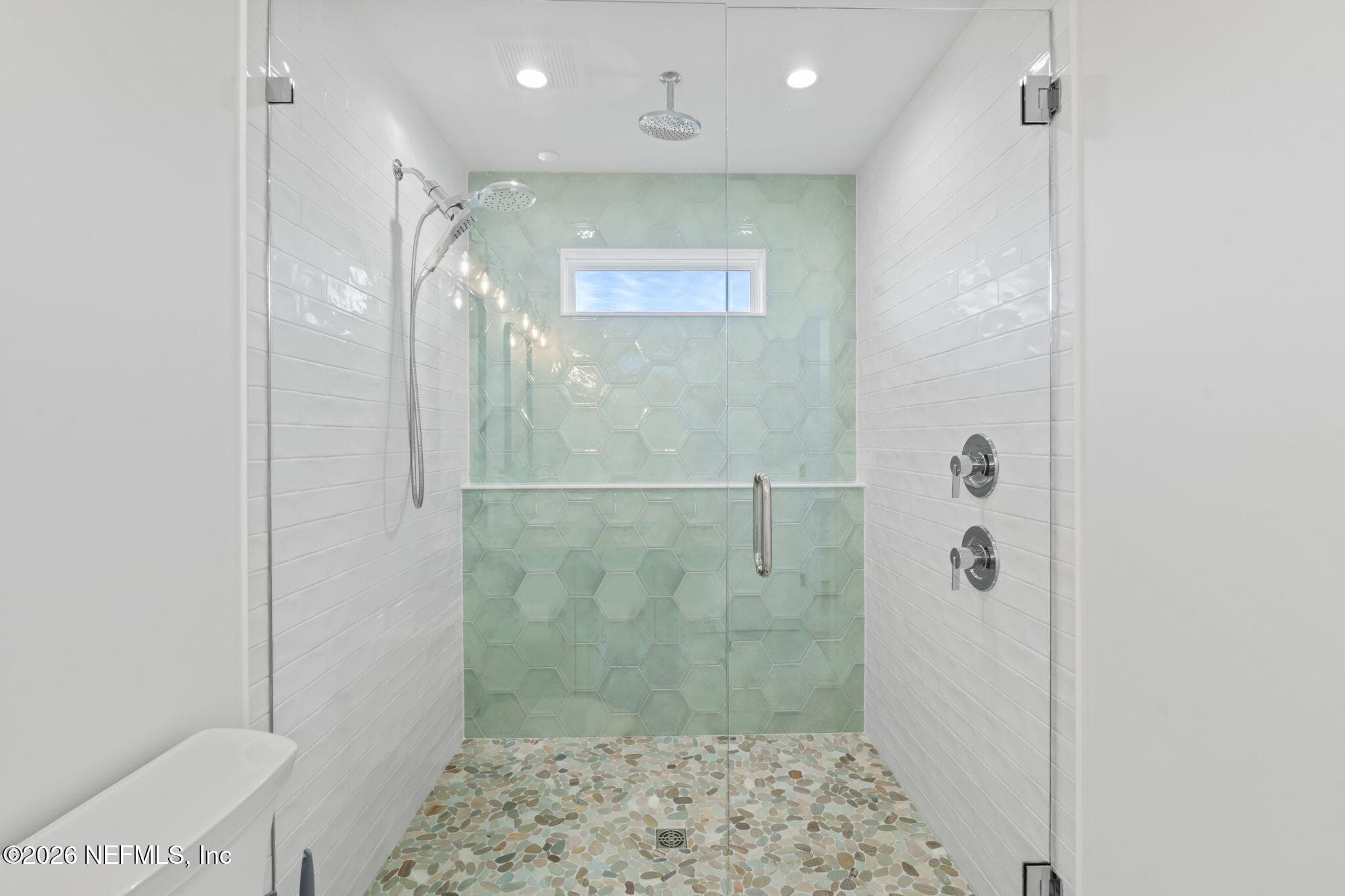 Verso Combination shower featuring Infiniti dial offers both a rainshower and hand shower in one sleek design, plus additional railhead from ceiling overhead — 921 2ND Avenue S, Jacksonville Beach, FL 32250
