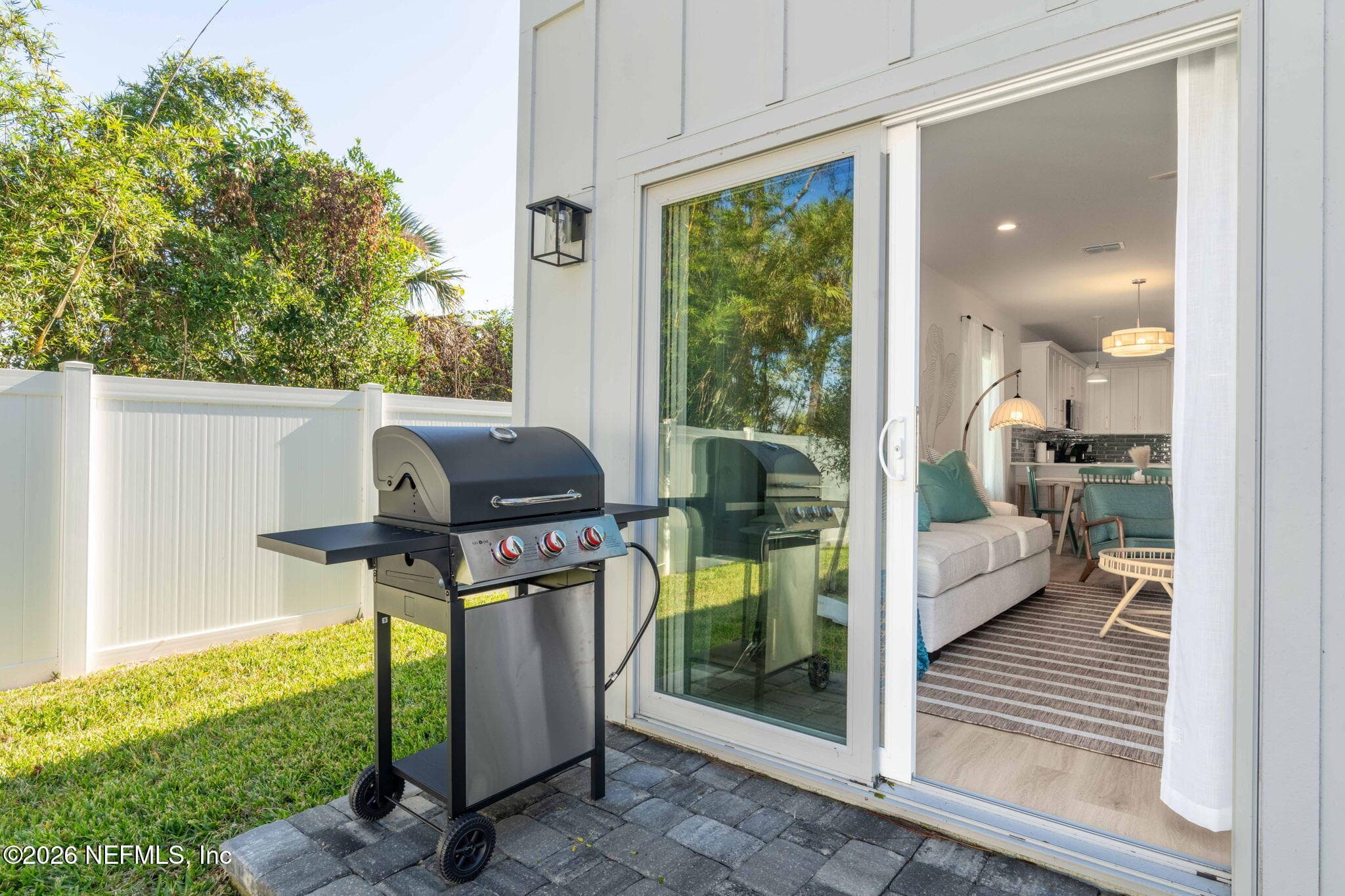 Sliding glass door leading out to fully fenced back yard — 921 2ND Avenue S, Jacksonville Beach, FL 32250