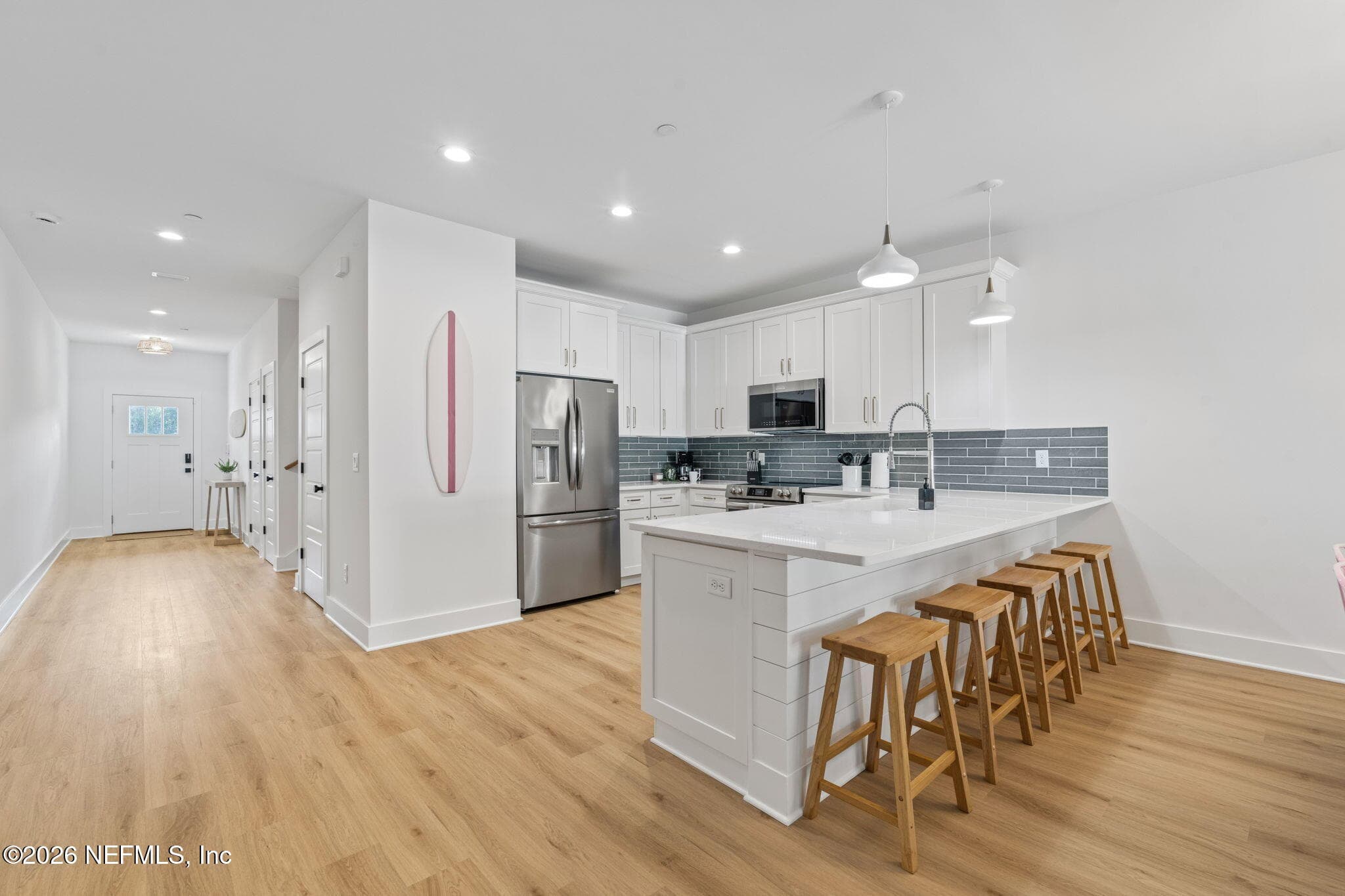Tiled backsplash, expansive counter depth bar seating, shiplap feature wall under bar top — 923 2ND Avenue S, Jacksonville Beach, FL 32250