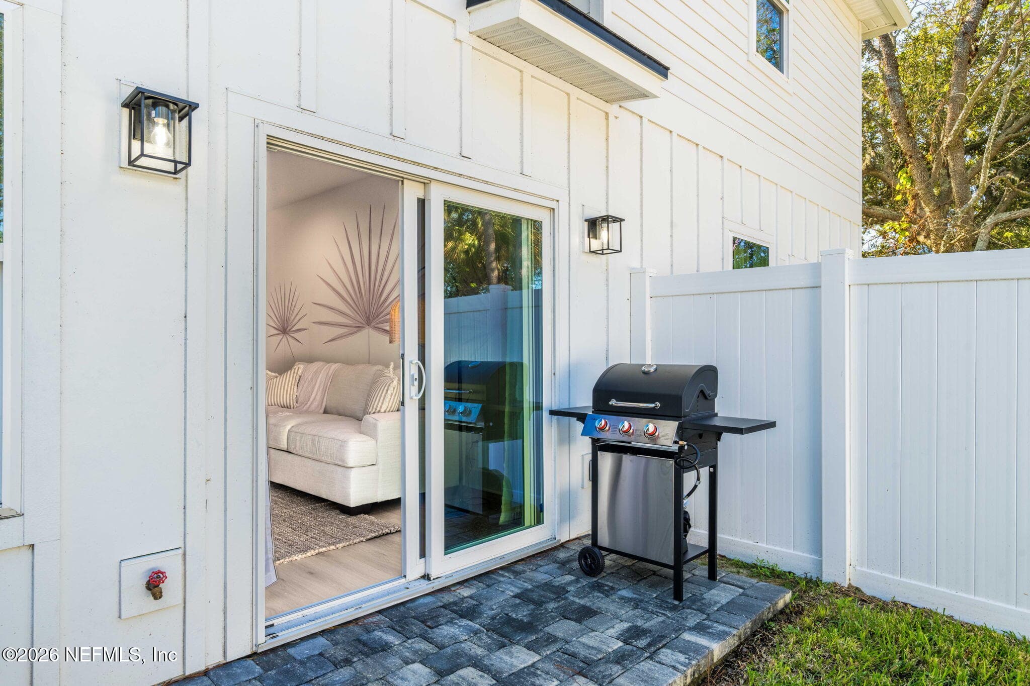 Sliding glass door leading to fully fenced back yard — 923 2ND Avenue S, Jacksonville Beach, FL 32250