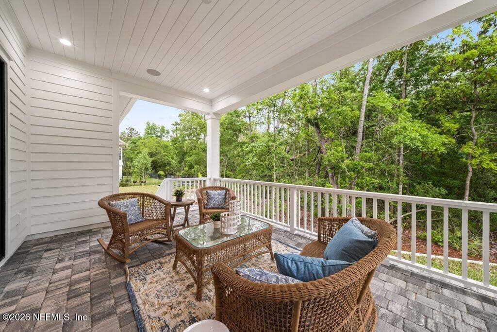 Relax on the large covered lanai overlooking the natural preserve. — 4575 SWILCAN BRIDGE Lane N, Jacksonville, FL 32224