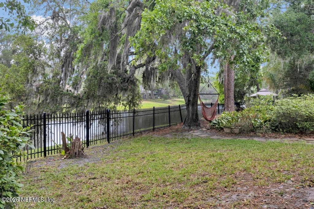 fully fenced backyard overlooks lagoon — 1943 ROSE MALLOW Lane, Fleming Island, FL 32003