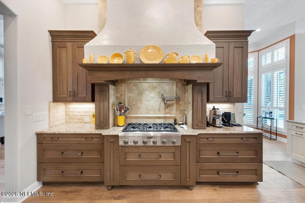 custom Venetian plaster hood over Thermador range with pot filler — 1943 ROSE MALLOW Lane, Fleming Island, FL 32003