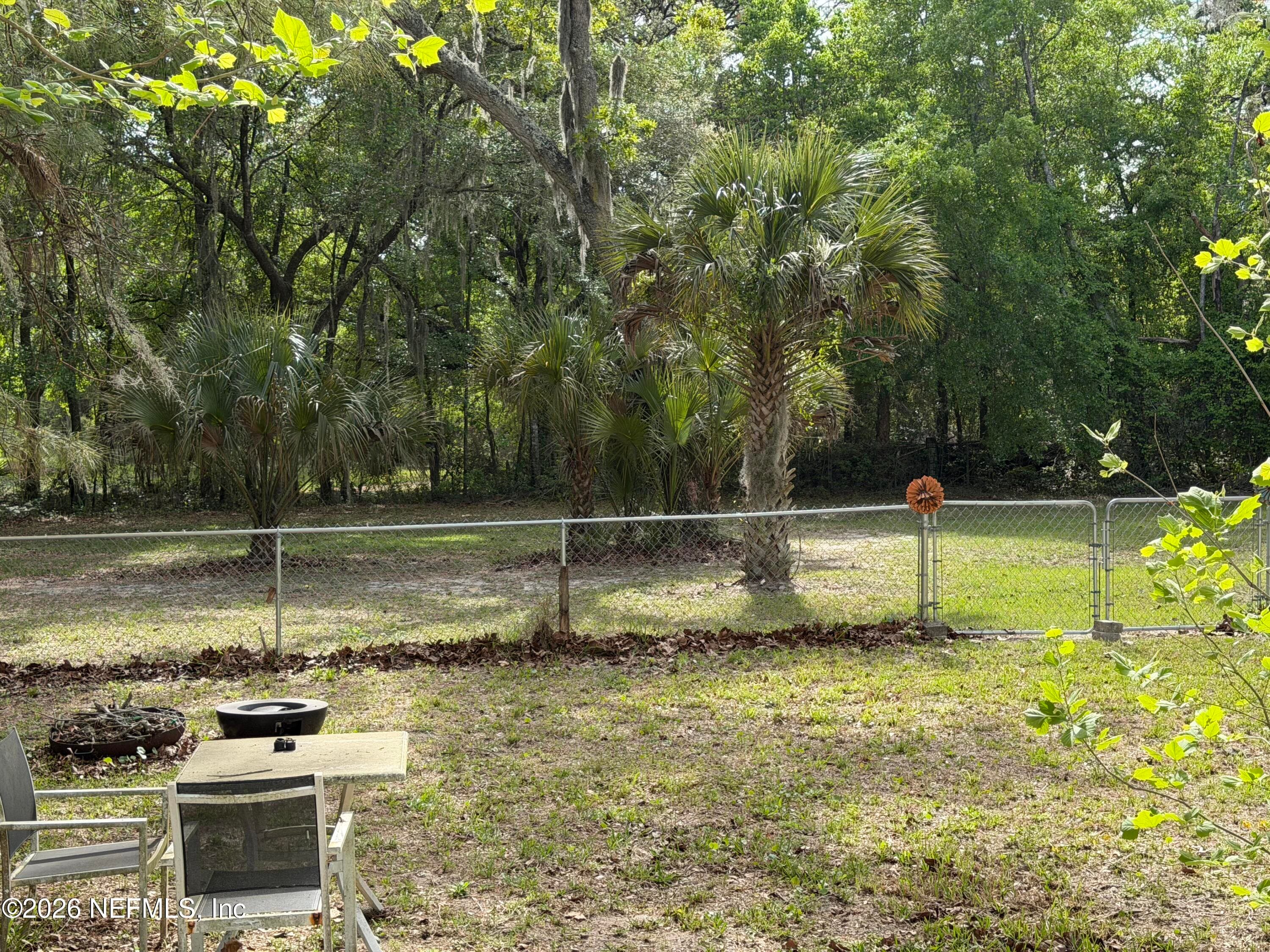 Back yard has cyclone fence, property extends way beyind the fence line in the back — 85045 LONNIE CREWS Road, Fernandina Beach, FL 32034