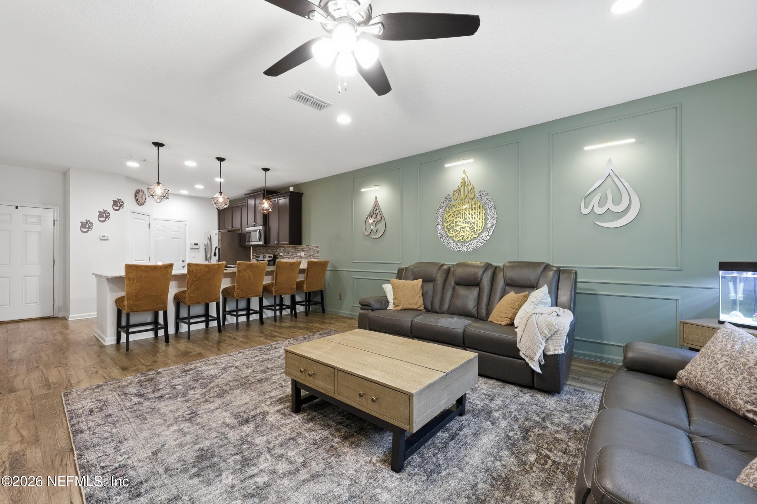 Light-filled living space with a functional open layout connecting to the kitchen, creating a comfortable and welcoming environment. — 3650 CRESWICK Circle C, Orange Park, FL 32065