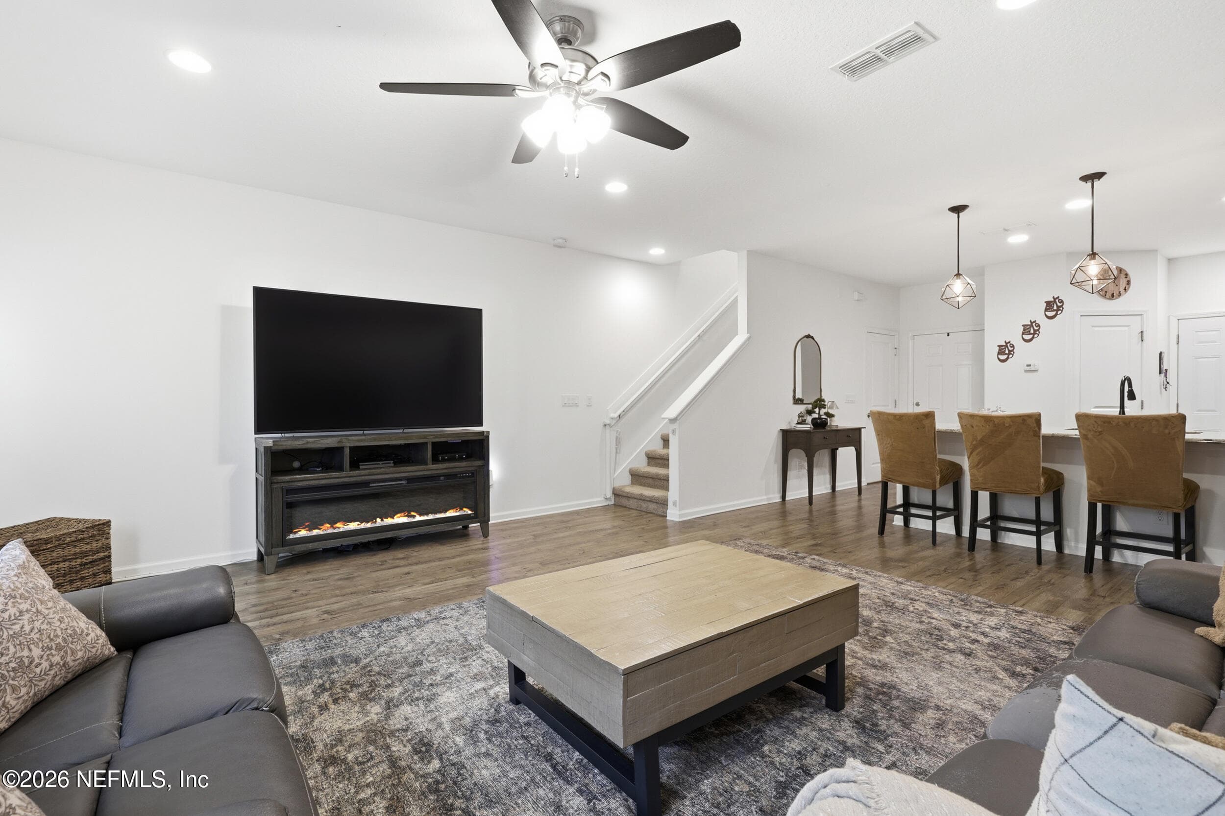 View of the living area highlighting the staircase and layout, offering a functional flow between levels. — 3650 CRESWICK Circle C, Orange Park, FL 32065