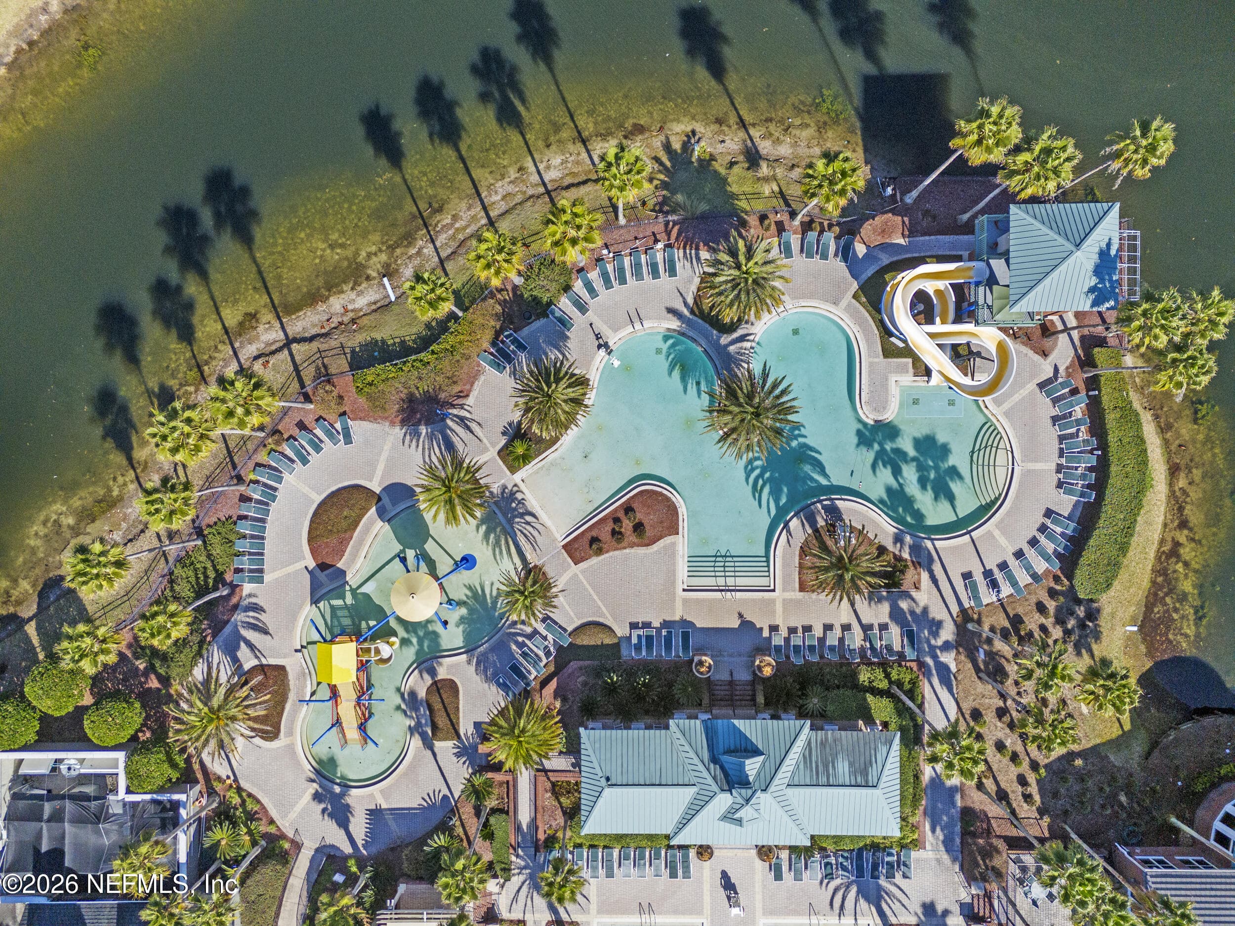 Aerial view of the resort-style pool complex featuring a waterslide and expansive lounging areas. — 3650 CRESWICK Circle C, Orange Park, FL 32065