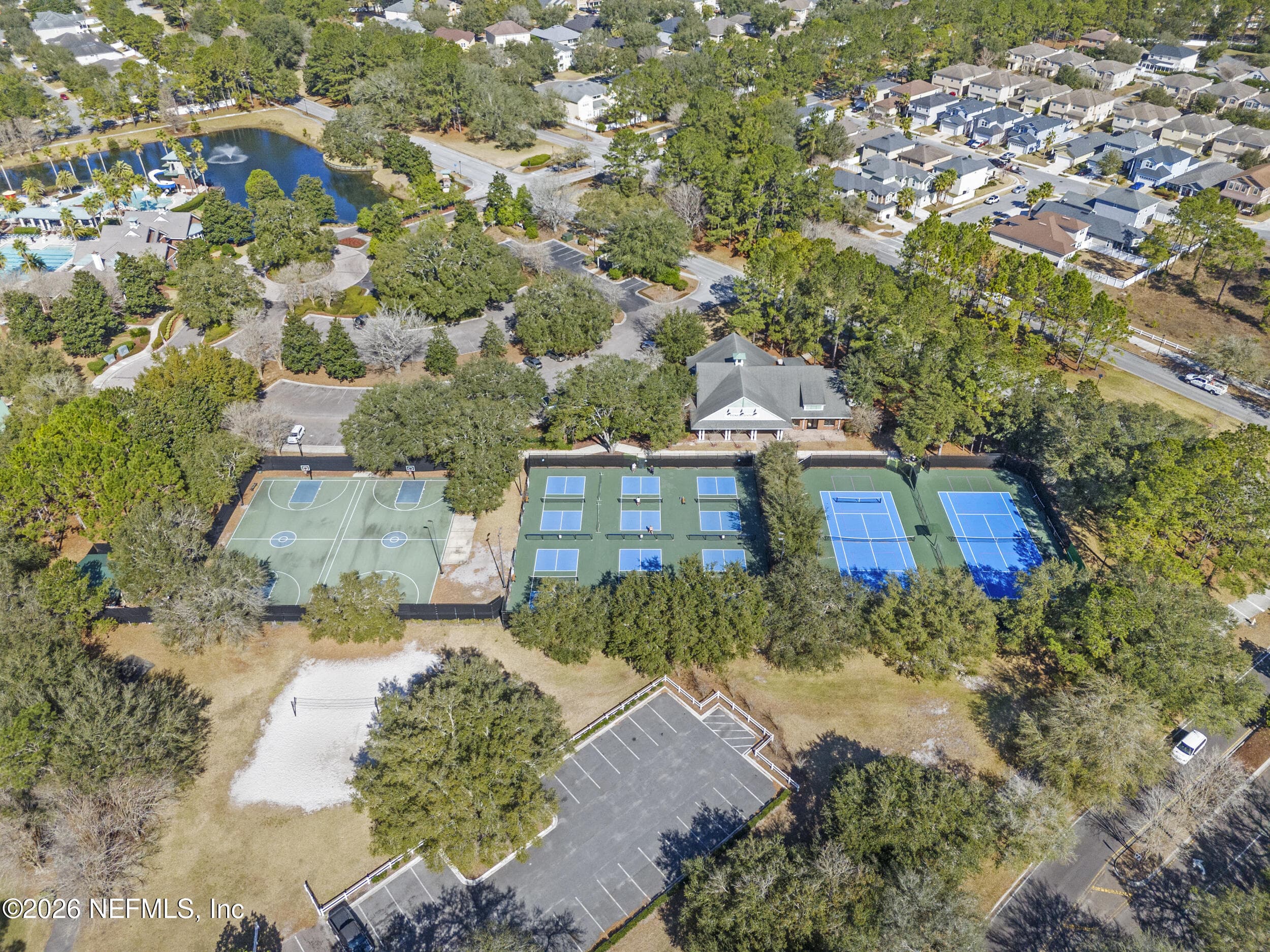 Aerial view of multiple courts for tennis, pickleball, and basketball, offering a variety of options for staying active within the community. — 3650 CRESWICK Circle C, Orange Park, FL 32065