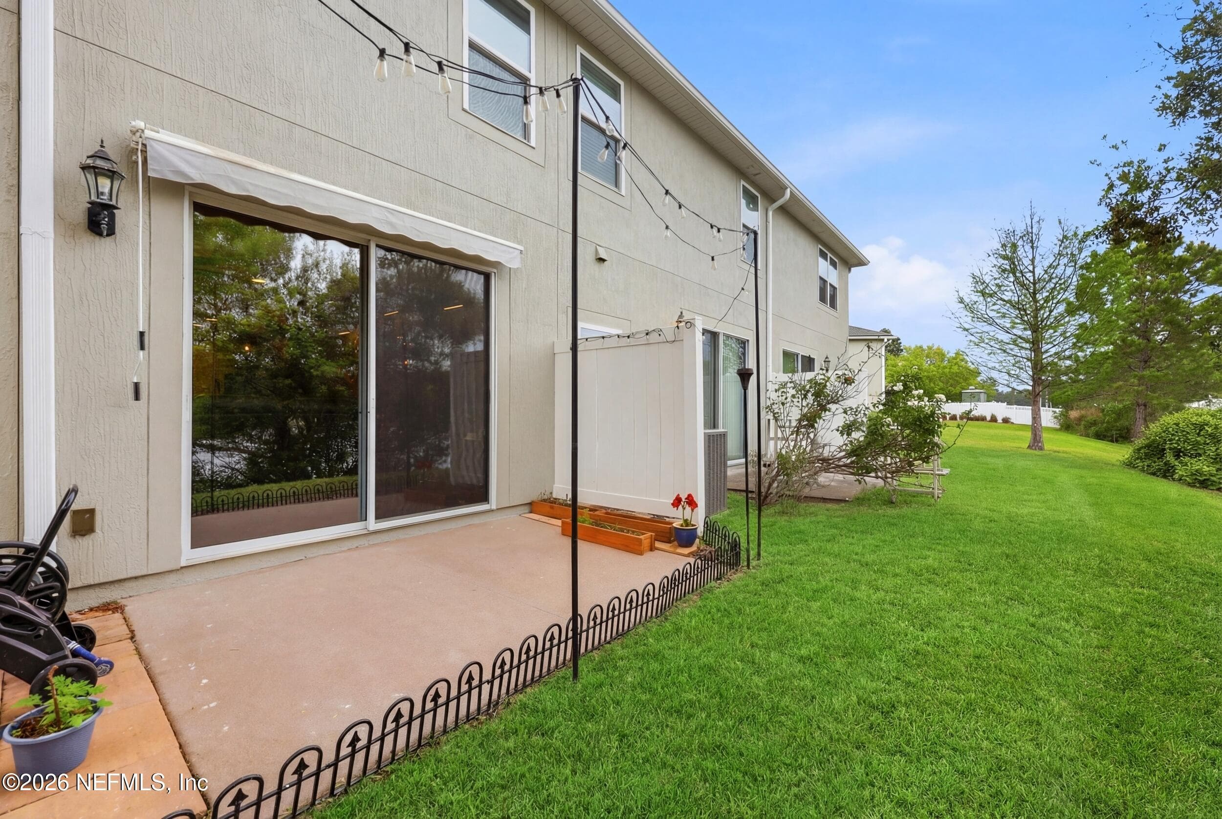 Private patio just off the sliding glass doors, featuring a retractable awning for optional shade and outdoor comfort. — 3650 CRESWICK Circle C, Orange Park, FL 32065