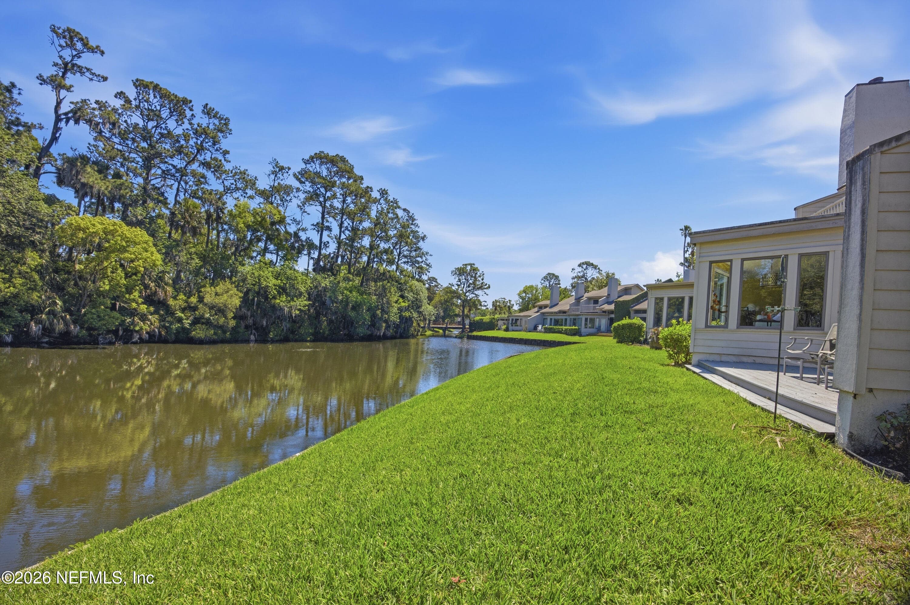 Deck and sunroom overlook the water and mature trees — 94 PLAYERS CLUB VILLAS Road, Ponte Vedra Beach, FL 32082