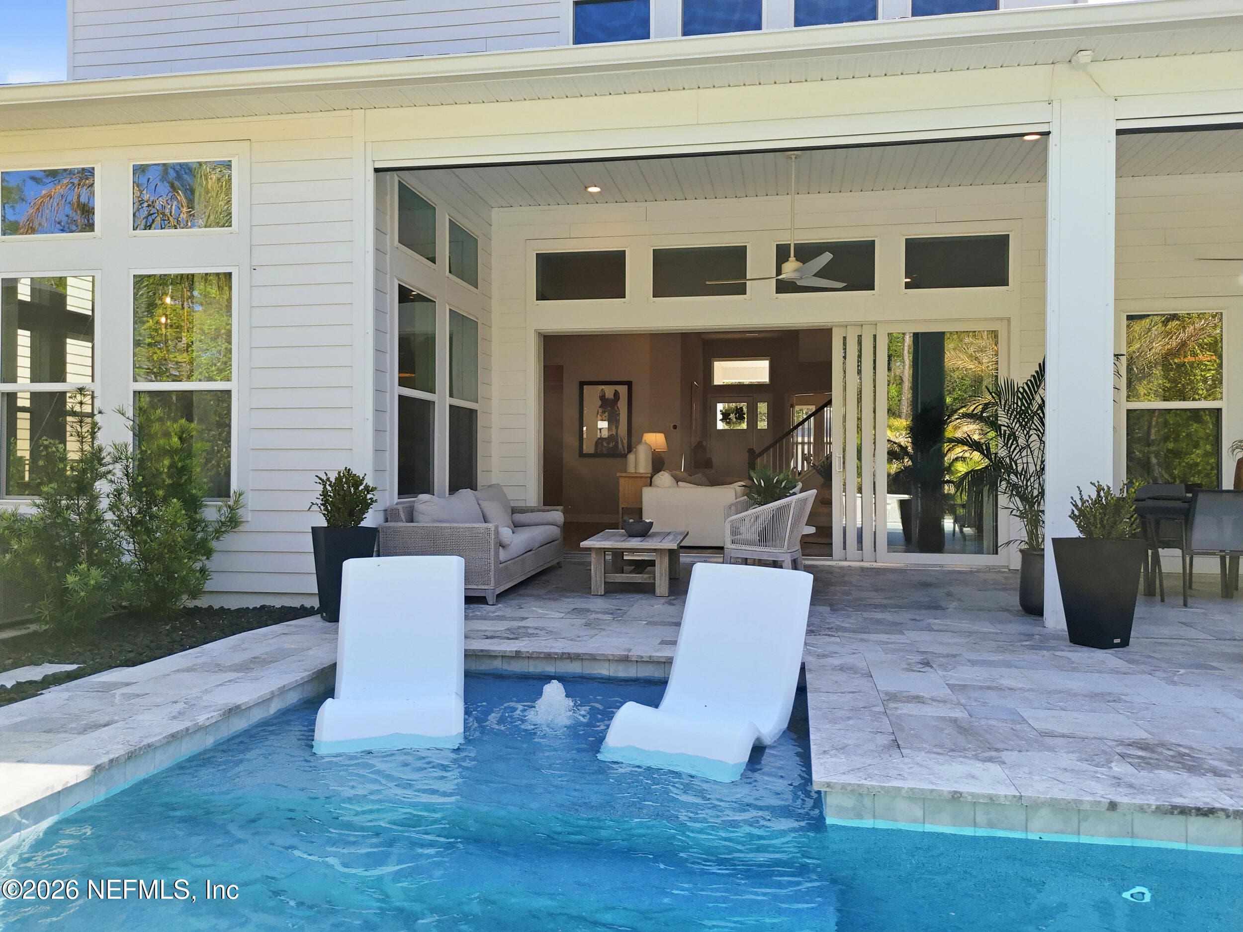 Backyard pool oasis showcasing sliding doors leading to the living room — 351 PALM CREST Drive, Ponte Vedra, FL 32081