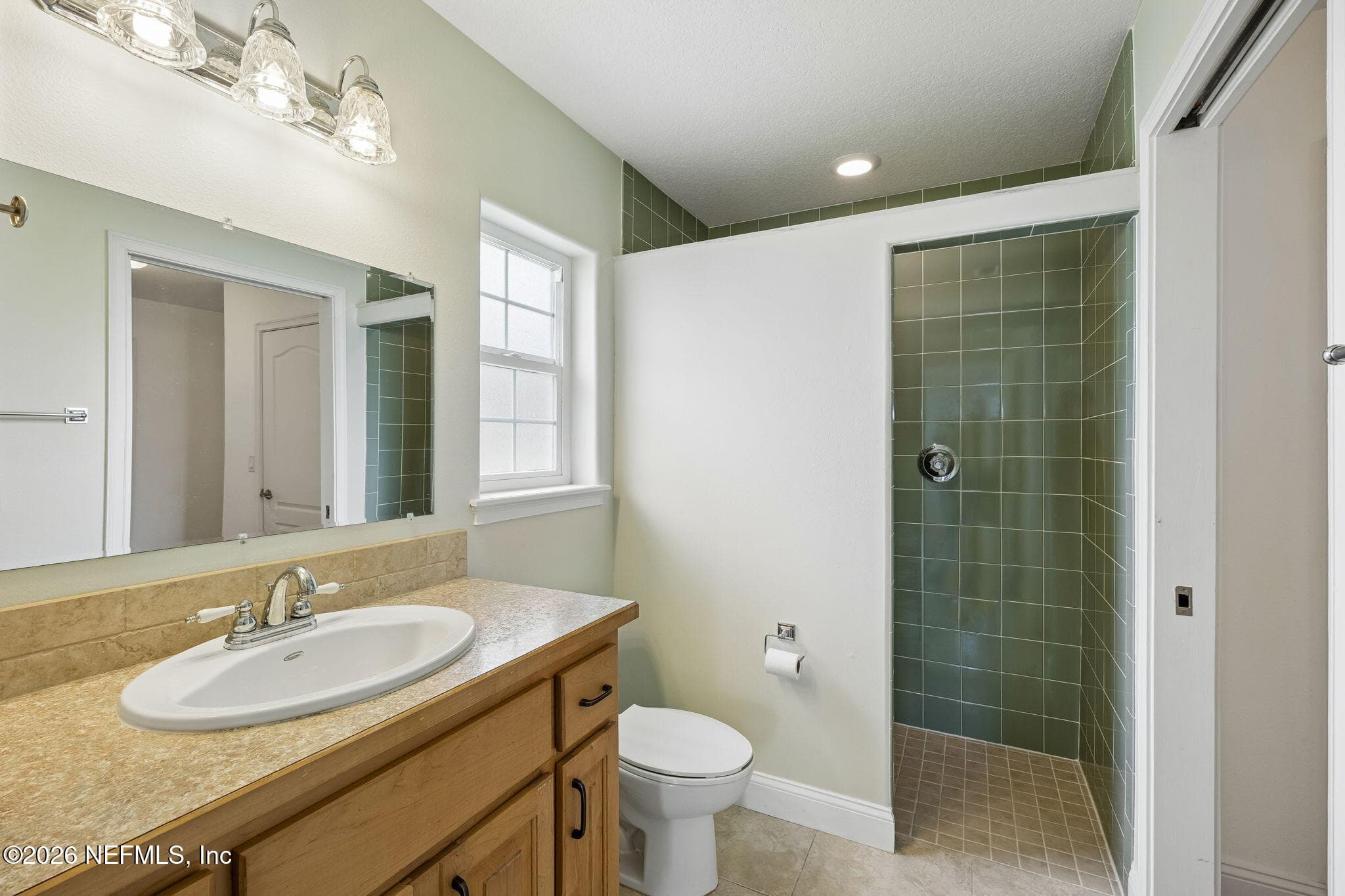 Includes a bathroom with tastefully tiled walk-in shower — 102 SANDRA Lane, Crescent City, FL 32112
