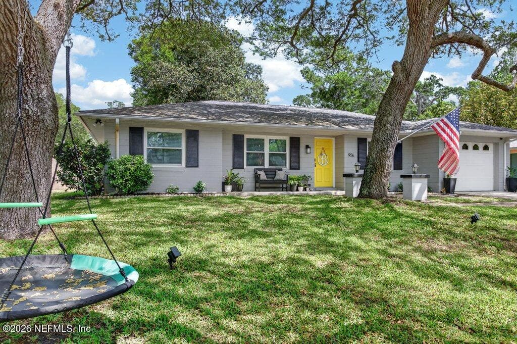 A picturesque view from the road emphasizing the expansive front lawn and the natural shade canopy that defines the neighborhood character. — 956 ESPINADO Avenue, St. Augustine, FL 32086