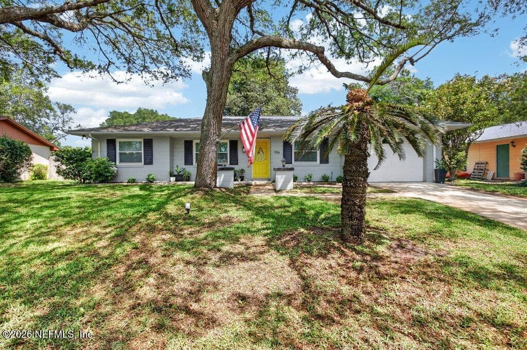 A balanced view of the home’s exterior featuring clean architectural lines and a welcoming, sun-drenched front yard. — 956 ESPINADO Avenue, St. Augustine, FL 32086