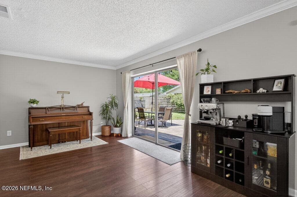 A secondary view of the main living area emphasizing the abundance of natural light and the direct access to the outdoor patio. — 956 ESPINADO Avenue, St. Augustine, FL 32086