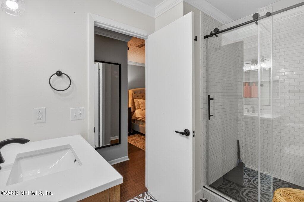 A contemporary bathroom renovation highlighting a walk-in shower with designer floor tiling and floor-to-ceiling subway tile walls. — 956 ESPINADO Avenue, St. Augustine, FL 32086