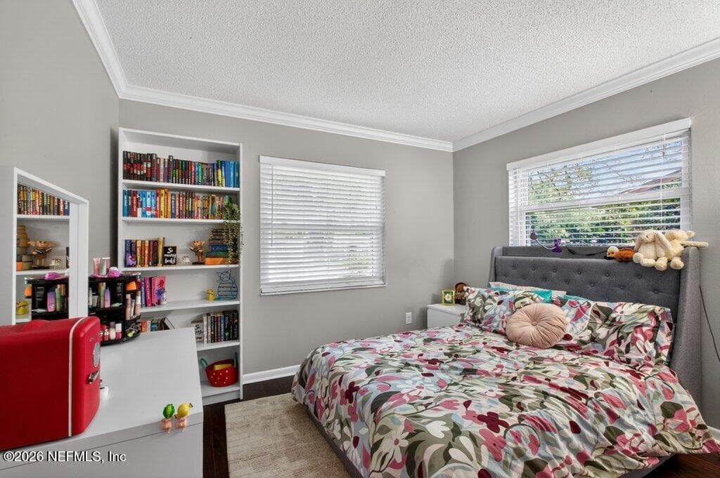 Another light-filled bedroom featuring wide-slat blinds and a spacious feel, maintaining the home's cohesive modern-traditional aesthetic. — 956 ESPINADO Avenue, St. Augustine, FL 32086
