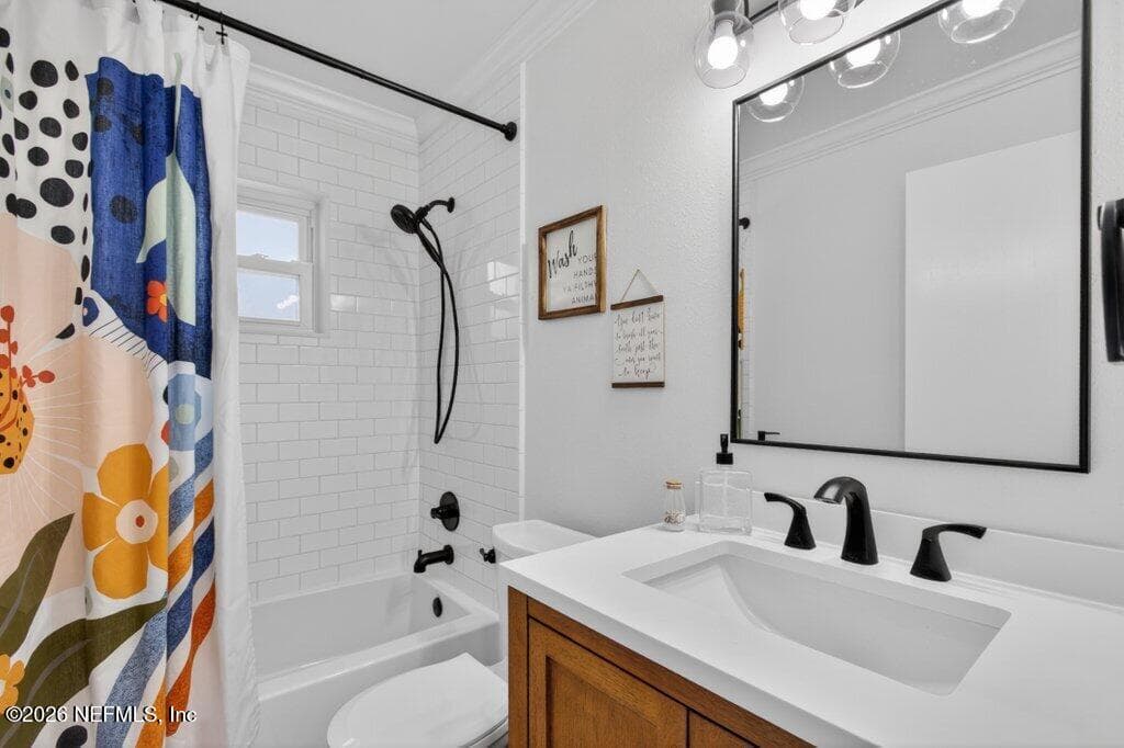 Clean and crisp bathroom design featuring a subway-tiled shower, updated vanity, and bright, neutral finishes. — 956 ESPINADO Avenue, St. Augustine, FL 32086