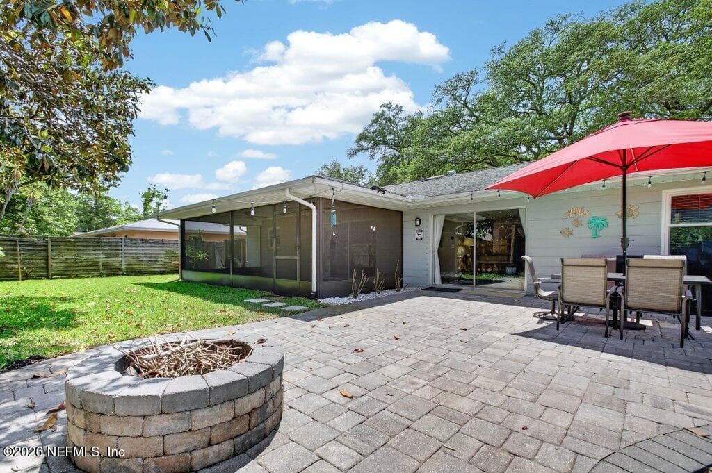 A closer look at the expansive paver patio and custom stone fire pit, ideal for evening gatherings in a fully fenced, private setting. — 956 ESPINADO Avenue, St. Augustine, FL 32086