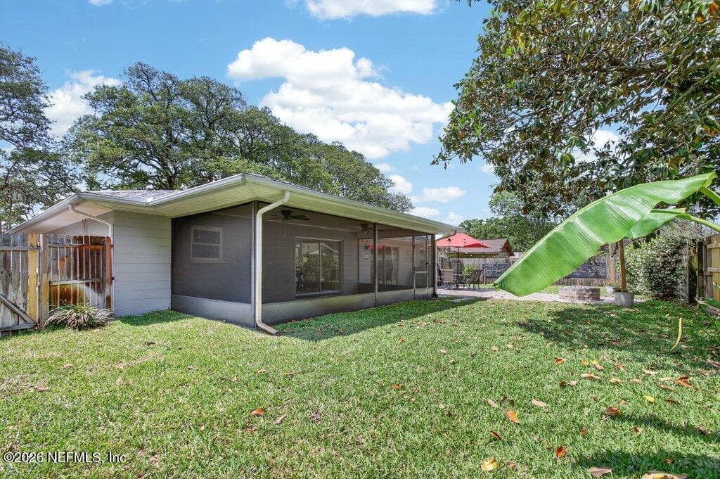Large, fully fenced backyard featuring a screened-in porch and plenty of green space for outdoor activities and gardening. — 956 ESPINADO Avenue, St. Augustine, FL 32086