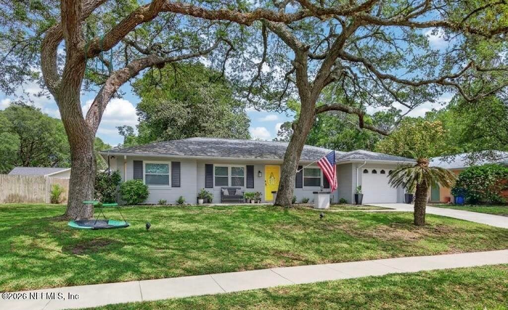 A picturesque view from the road emphasizing the property's setback and the sprawling canopy that provides natural shade and privacy. — 956 ESPINADO Avenue, St. Augustine, FL 32086