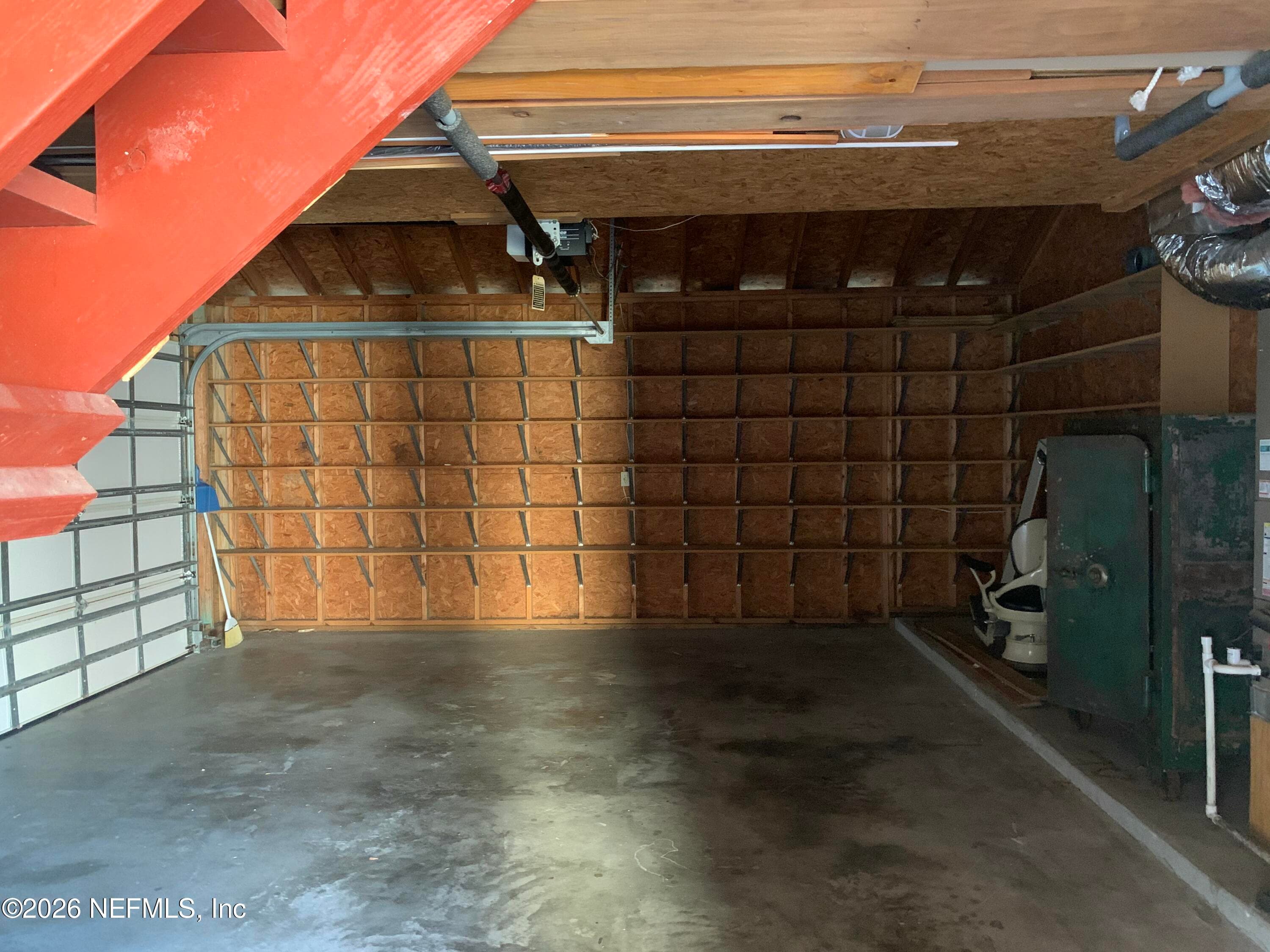 Larger garage with shelving & stairway to Apartment bedroom. Stackable W/D in garage. — 120 BEACH Avenue, Atlantic Beach, FL 32233