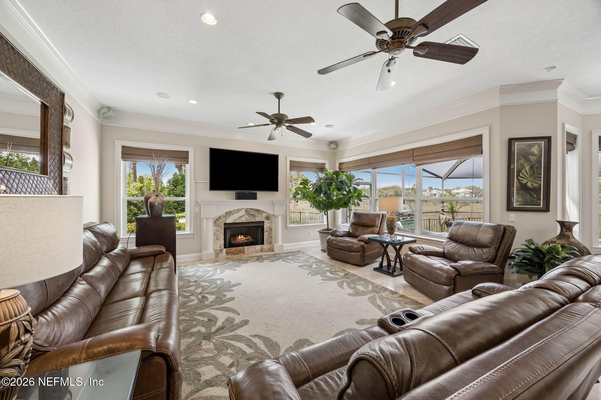In the family room, a striking wall of windows invites in abundant natural light, filling the space with warmth and creating a bright, welcoming setting for everyday living. — 188 CLEARLAKE Drive, Ponte Vedra Beach, FL 32082