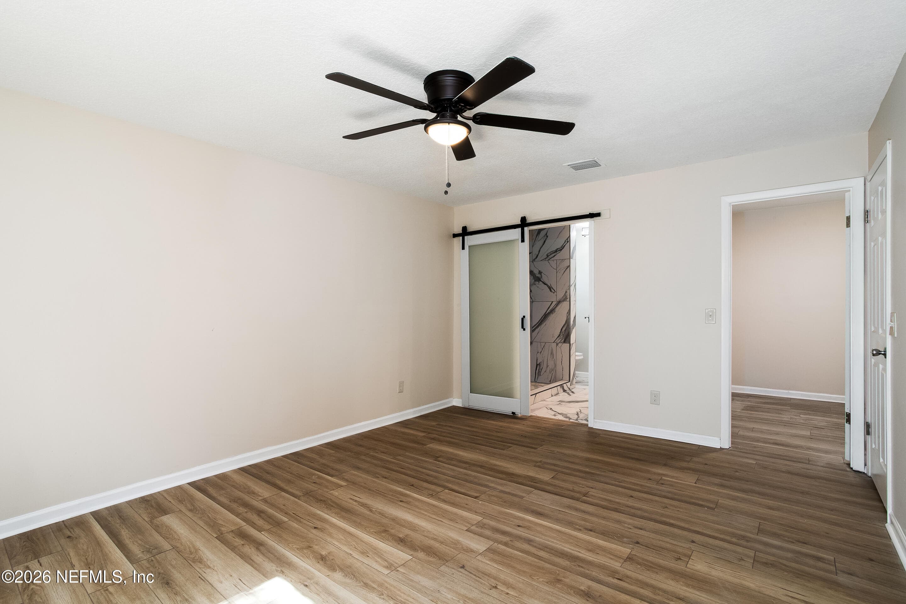 Barn doors to bathroom and entrance to walk in closet — 1225 BEE Street N, Orange Park, FL 32065