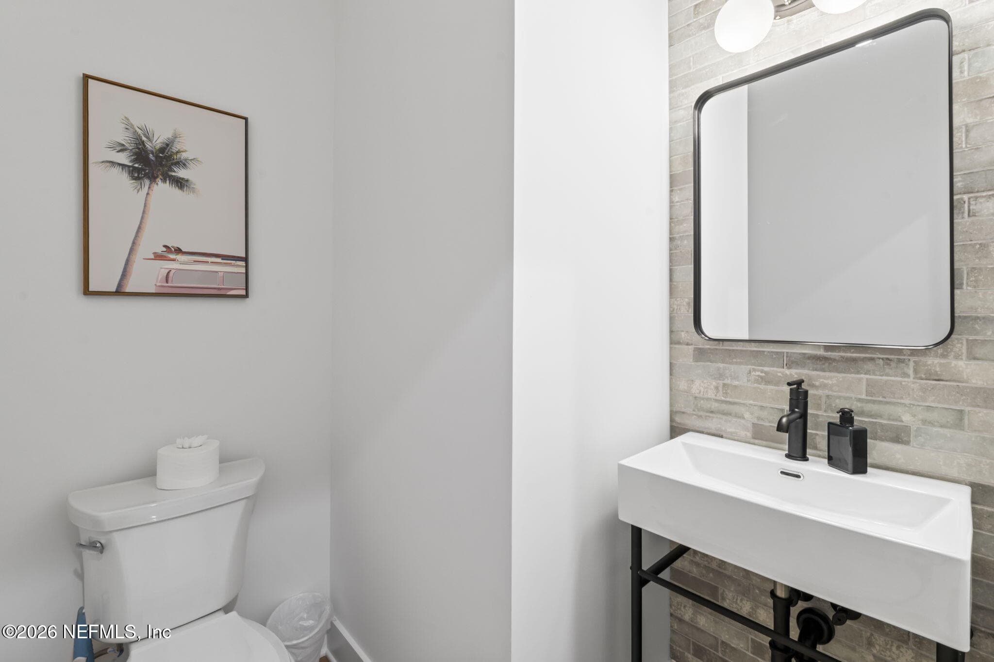Downstairs powder Bath with tile feature wall — 925 2ND Avenue S, Jacksonville Beach, FL 32250