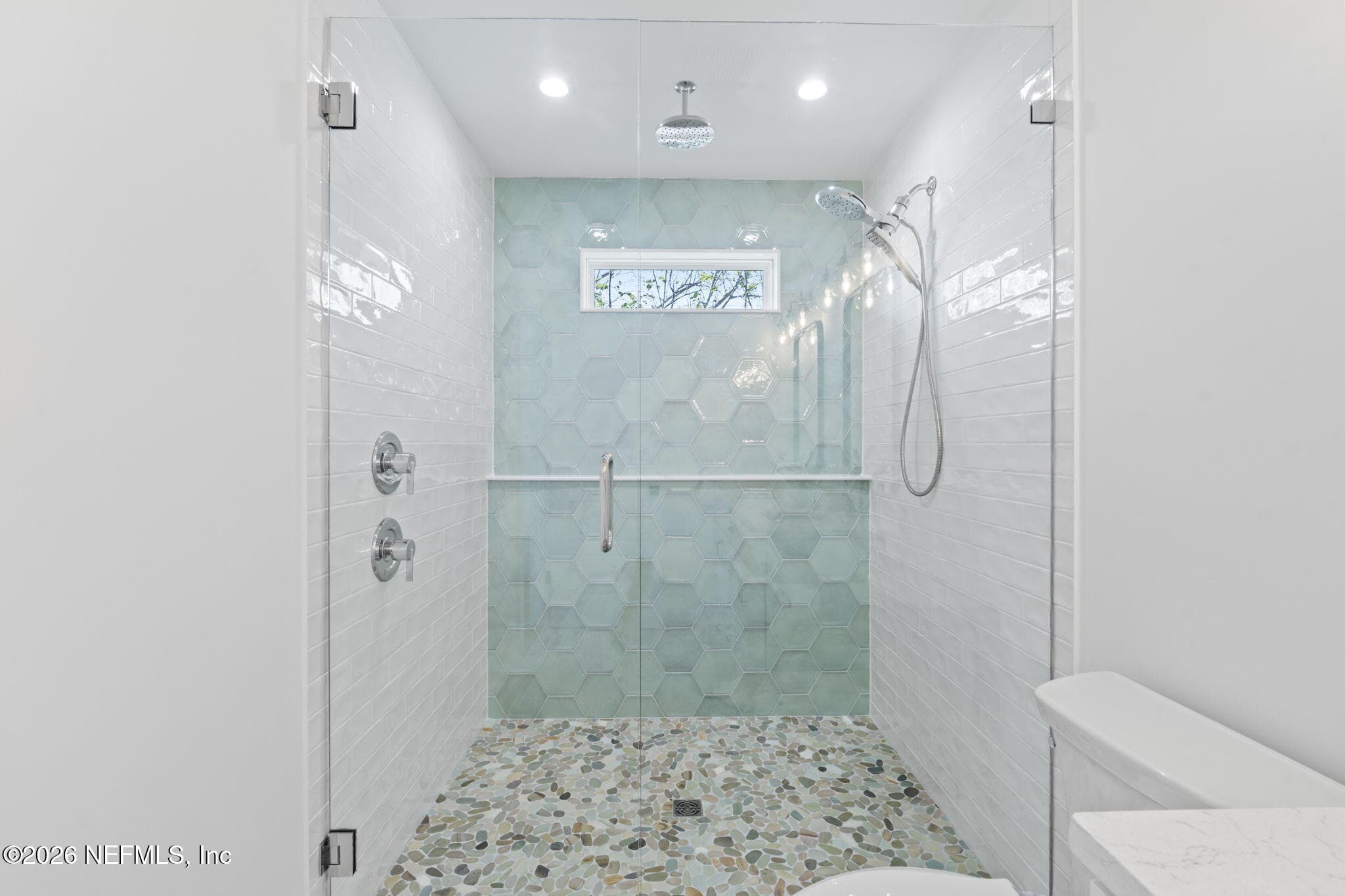 Verso Combination shower featuring Infiniti dial offers both a rainshower and hand shower in one sleek design, plus additional railhead from ceiling overhead — 925 2ND Avenue S, Jacksonville Beach, FL 32250