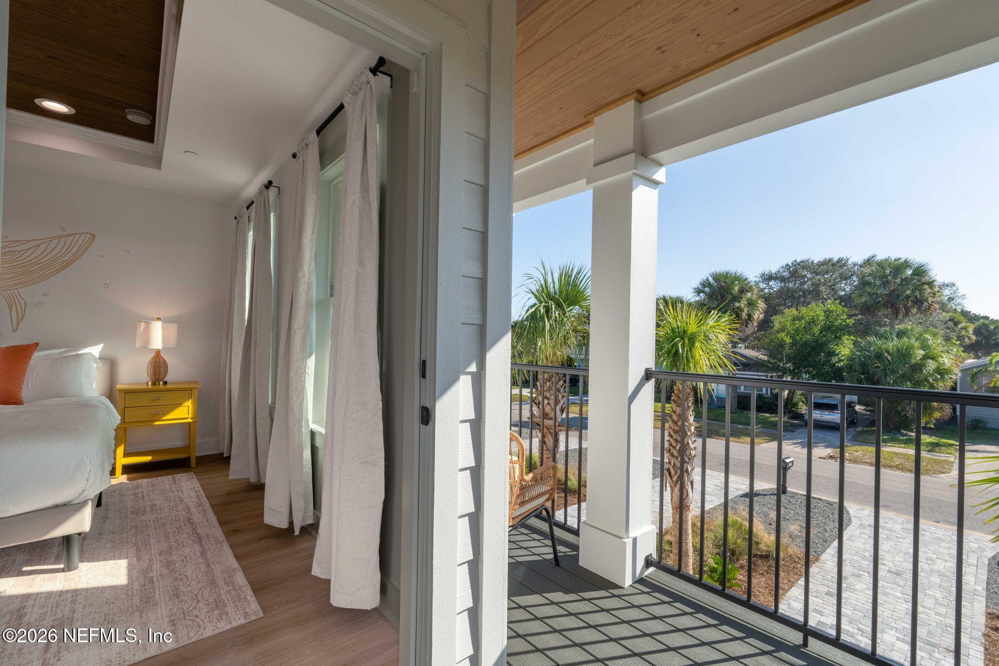 2nd floor covered balcony off of primary bedroom with low maintenance composite decking and stained tongue and groove ceilings — 925 2ND Avenue S, Jacksonville Beach, FL 32250