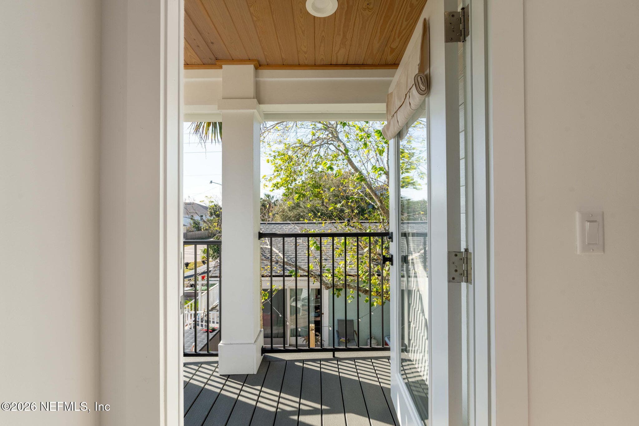 2nd floor covered balcony off of primary bedroom with low maintenance composite decking and stained tongue and groove ceilings — 925 2ND Avenue S, Jacksonville Beach, FL 32250