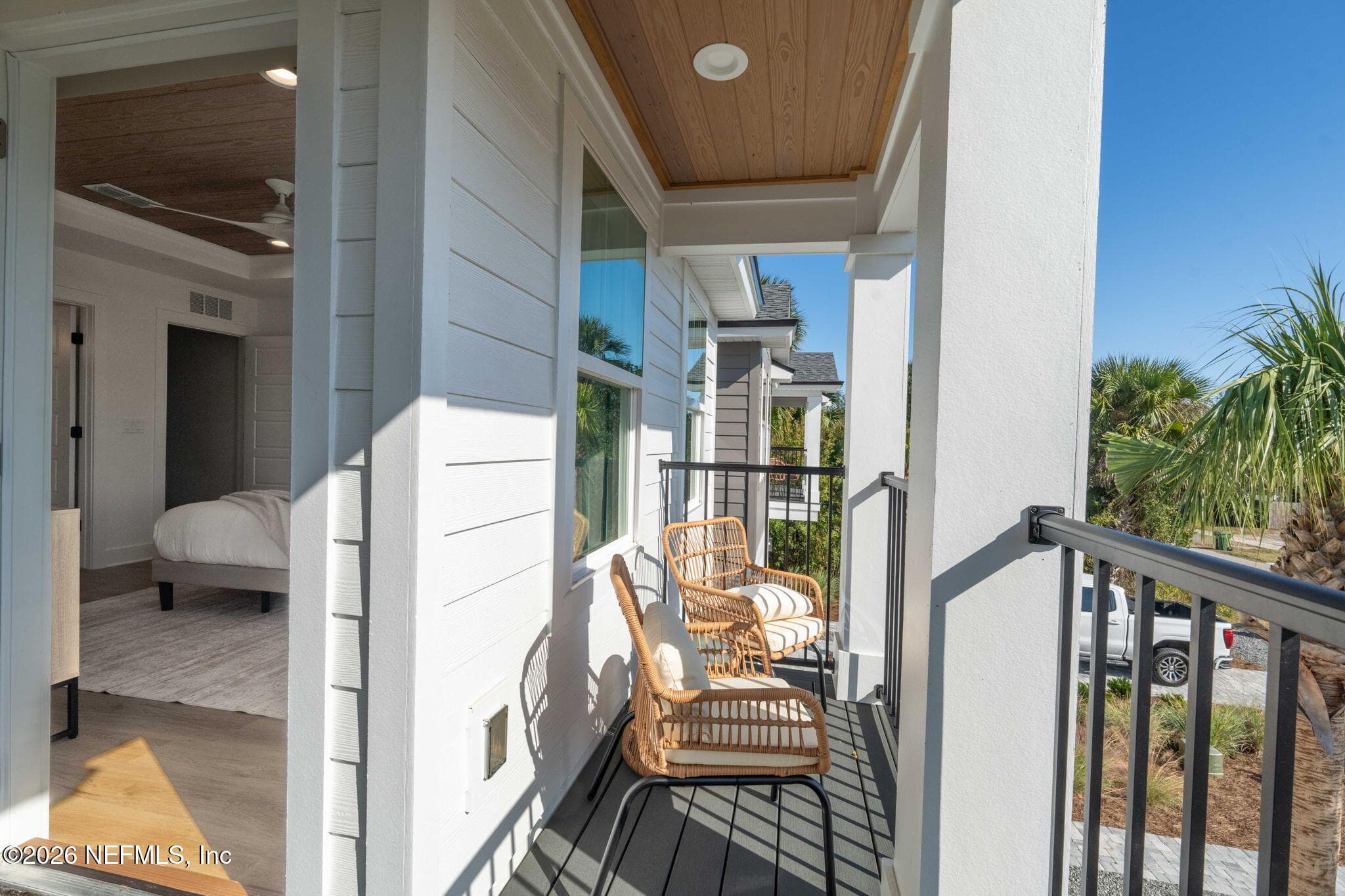 2nd floor covered balcony off of primary bedroom with low maintenance composite decking and stained tongue and groove ceilings — 925 2ND Avenue S, Jacksonville Beach, FL 32250