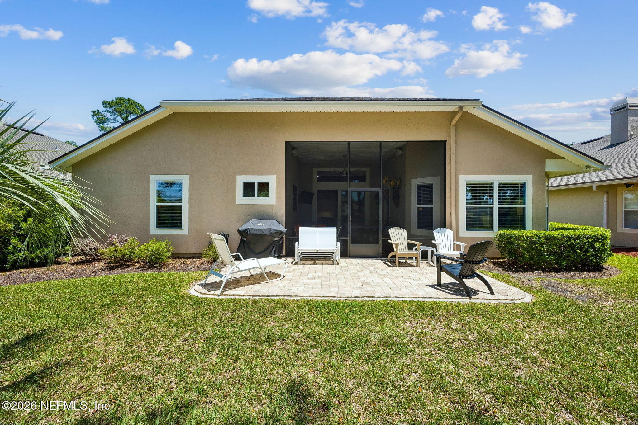Rear exterior of the home showcasing a well maintained backyard setting. — 85225 AMAGANSETT Drive, Fernandina Beach, FL 32034