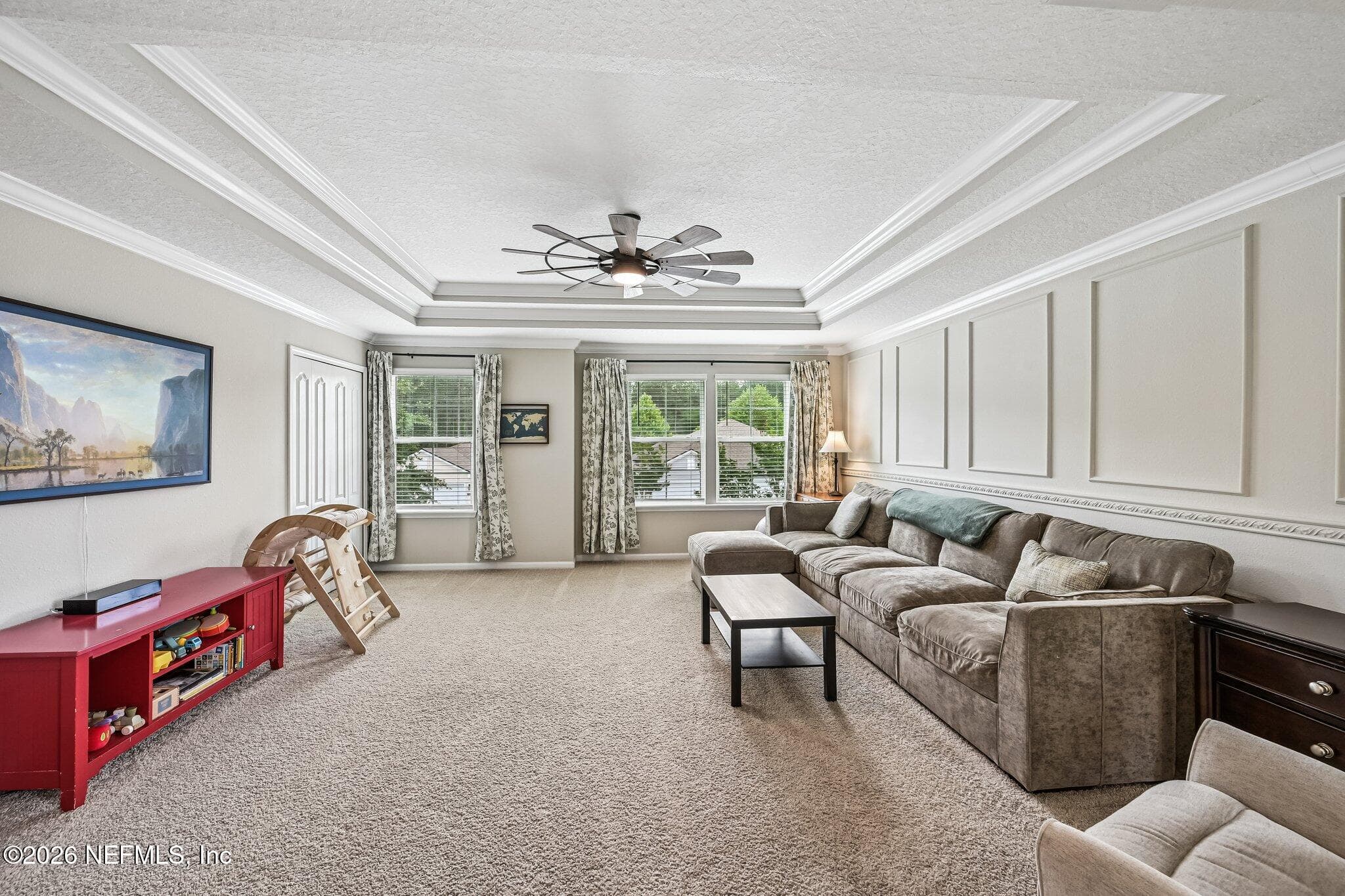 Large loft featuring tray ceilings and wainscoting, along with storage closet — 15694 CHIR PINE Drive, Jacksonville, FL 32218