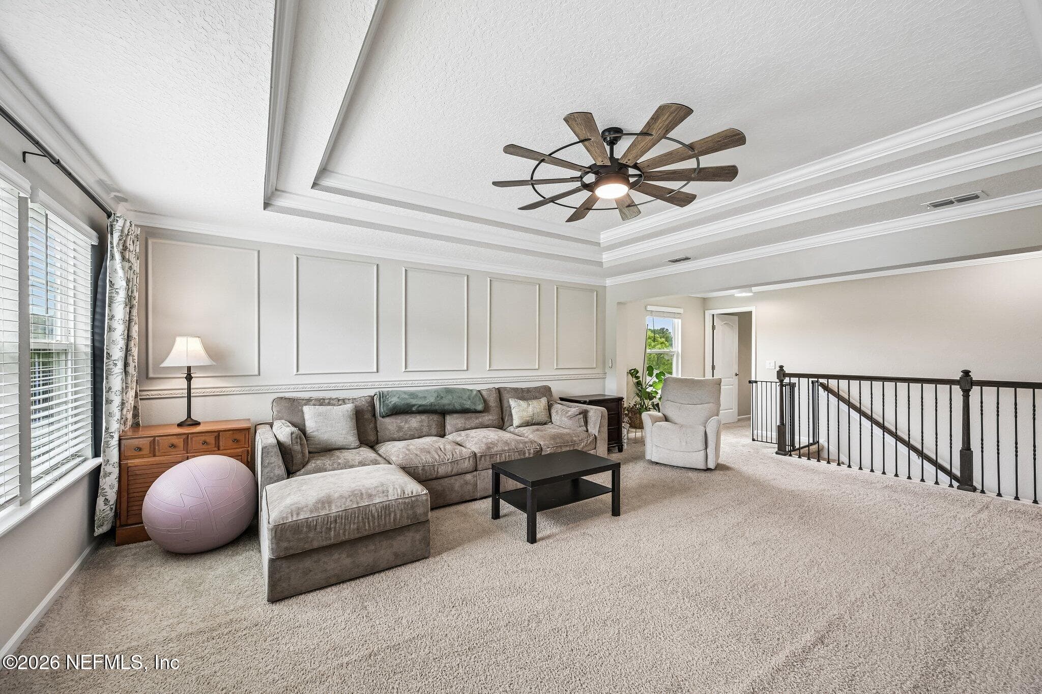 Large loft featuring tray ceilings and wainscoting, along with storage closet — 15694 CHIR PINE Drive, Jacksonville, FL 32218