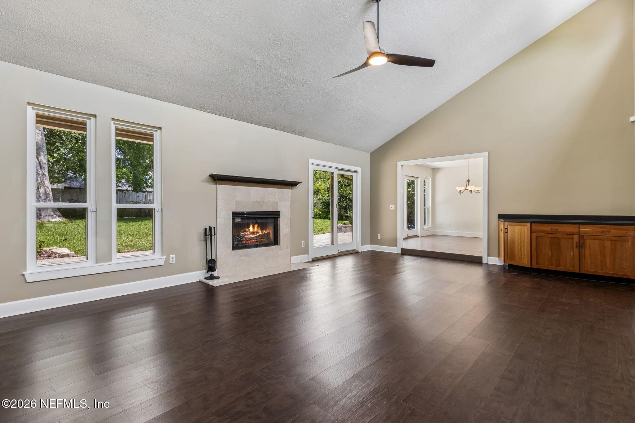 Living room with wood burning fireplace overlooks backyard. — 1877 CHRISTOPHER POINT Road S, Jacksonville, FL 32217